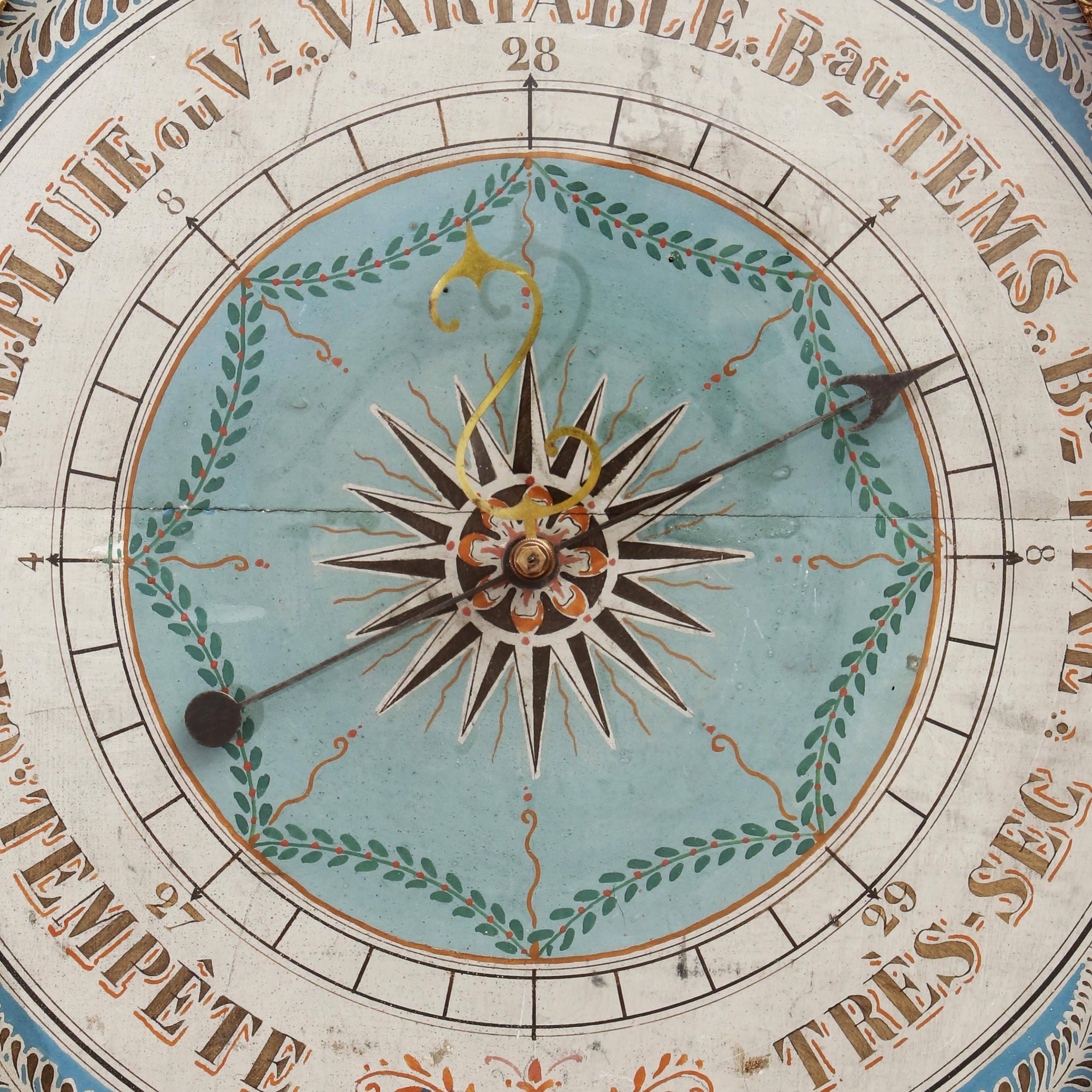 A fine early 19th century giltwood barometer with an unusual blue painted dial with central star motif. The hexagonal frame surmounted by a lyre top with a thermometer and a carved medallion.