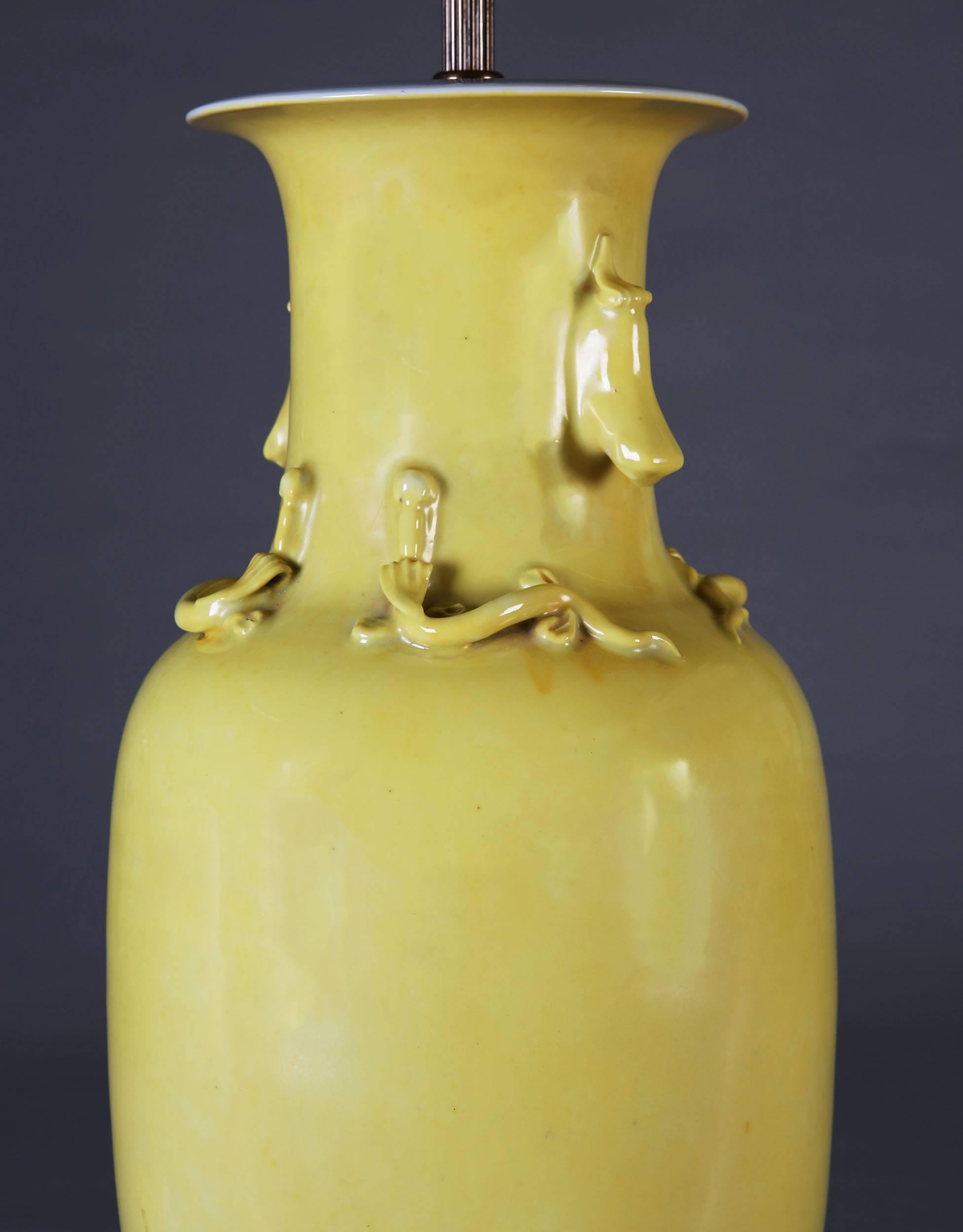A single 19th century Chinese lemon yellow lamp, with lizard mouldings to the neck.

  
