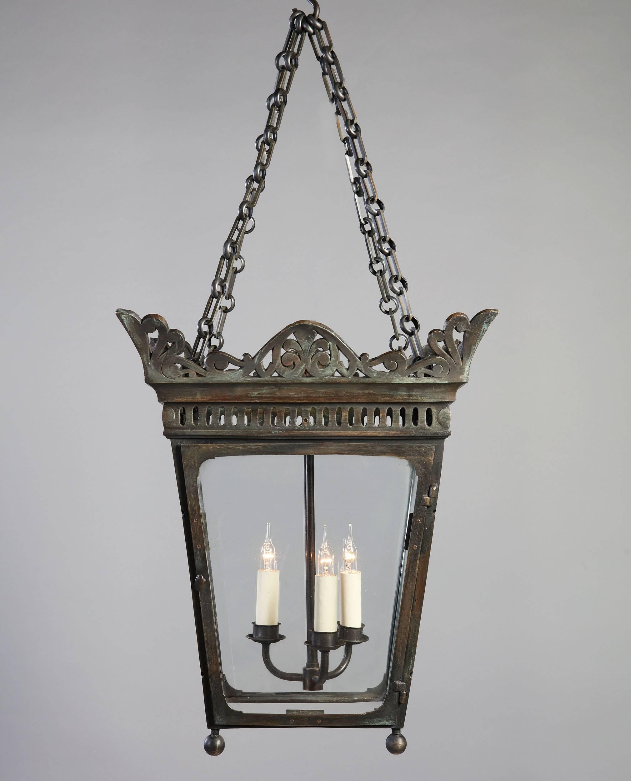 An early 19th century bronze hanging lantern with pierced cresting.