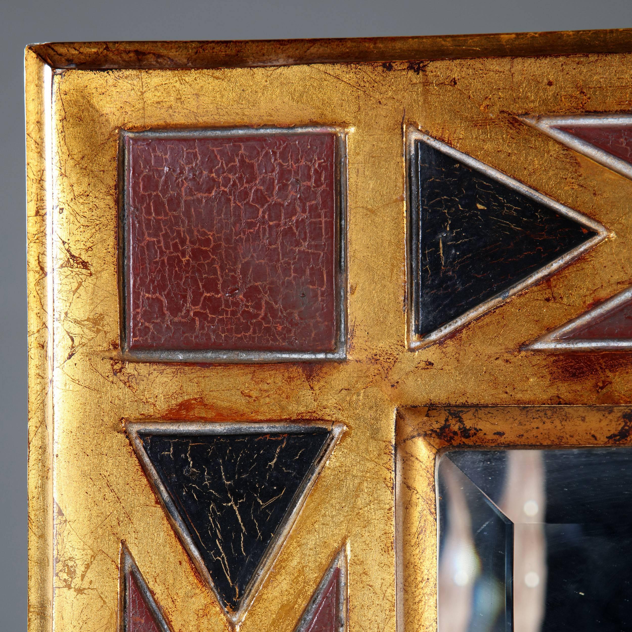 A large scale pair of carved and painted geometric mirrors decorated with diagonal red and ebonised panels with mercury glass mirror plates.