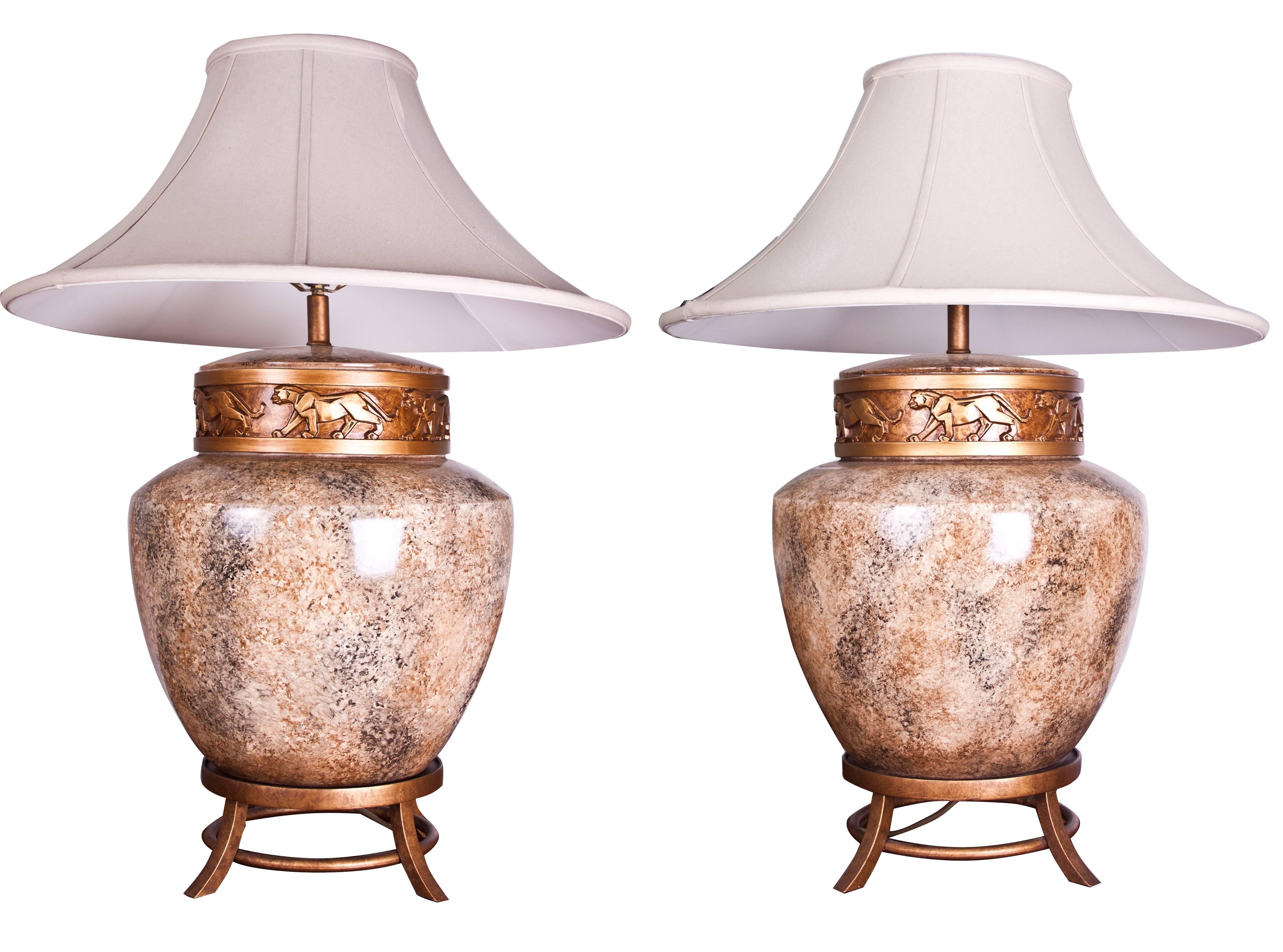A large pair of Art Deco style lamps with a Chinese influence, bulbous mottled ceramic body raised on tripod base with a freeze of lions.
USA, circa 1980.
Measures: H 83 cm, W 45 cm, D 45 cm.
