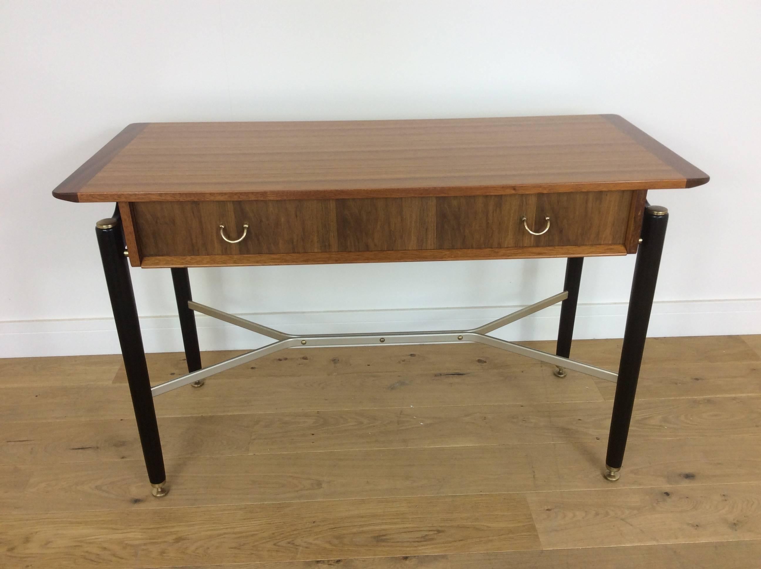 Mid-Century Modern design from the UK
A rare console table or desk beautifully presented in teak wood and ebony with polished brass fixtures, height adjustable feet, polished aluminium stretcher.
Designed by E Gomme for G Plan
British, circa