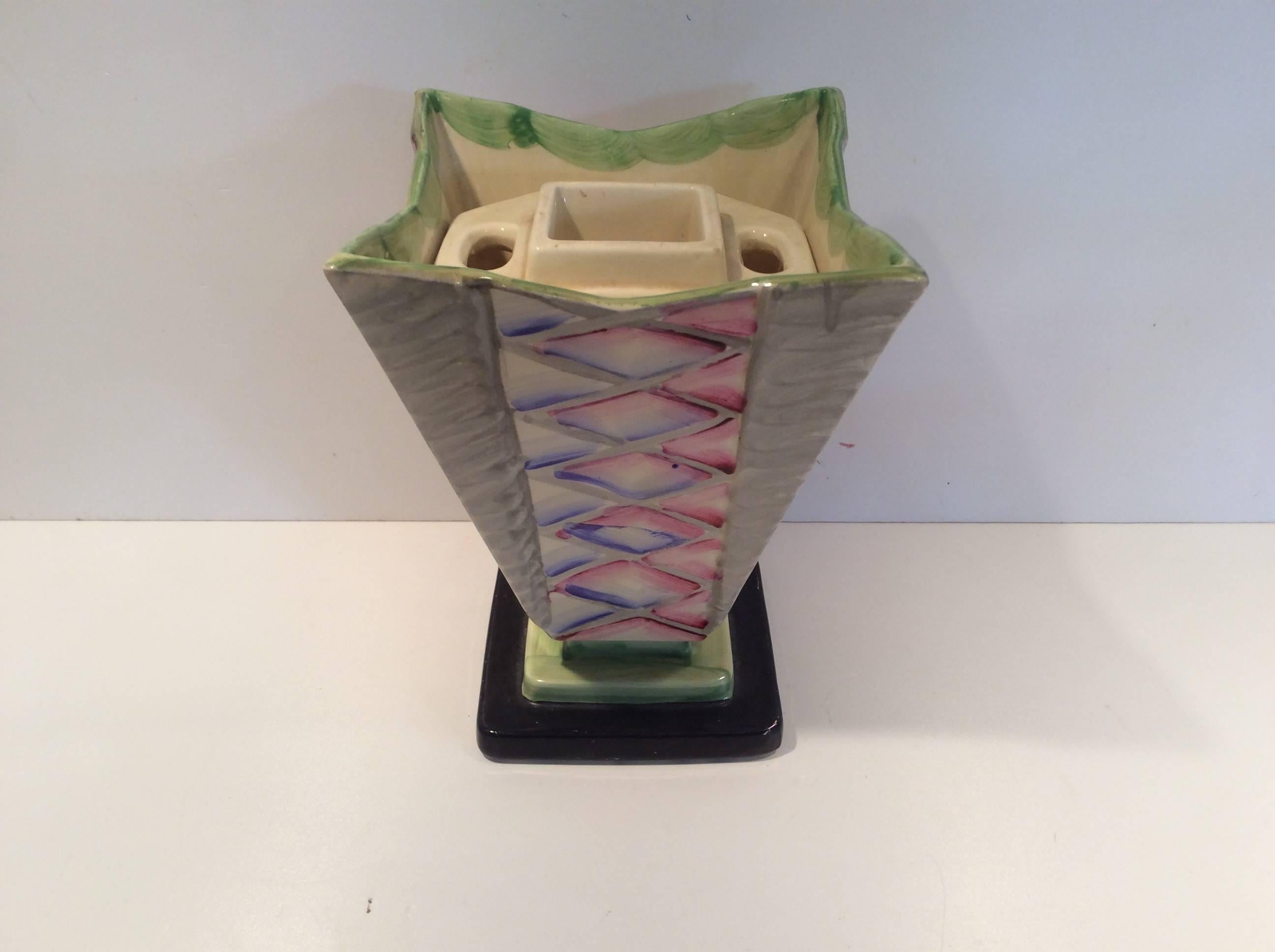 Unusual Art Deco hand-painted abstract design vase.
Star-shaped top to this striking original Art Deco vase.
Height to top is 18 cm 19 cm corner to corner and 14 cm sq. at the top.