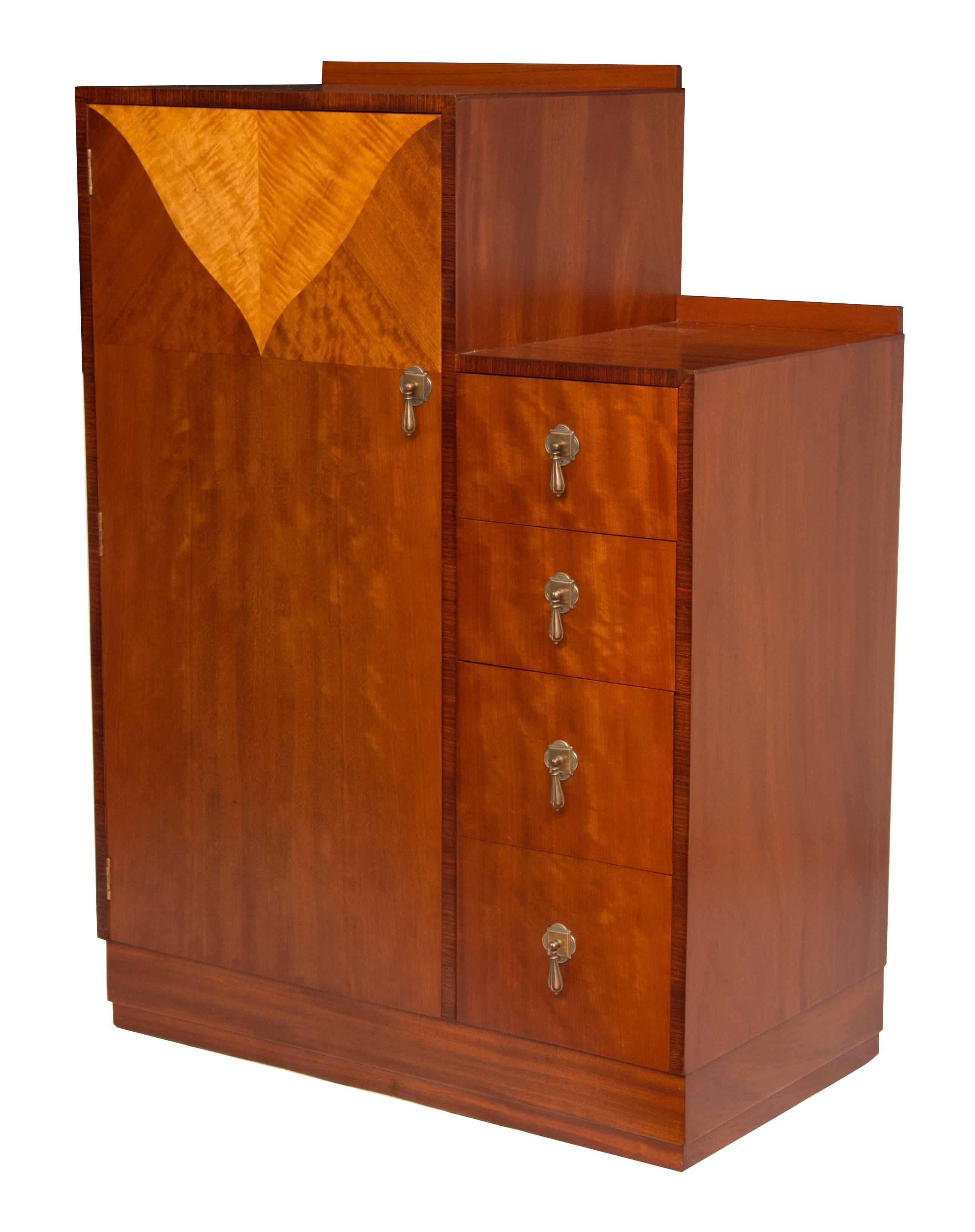 Art Deco gentleman’s Wardrobe.
Art Deco tallboy by Maple and Co, fine quality to this stunning gentleman’s wardrobe, beautiful satin walnut with satin maple detail and bronze handles.
Measures: 114 cm h at the front 117 cm h at the back 84 cm w 46