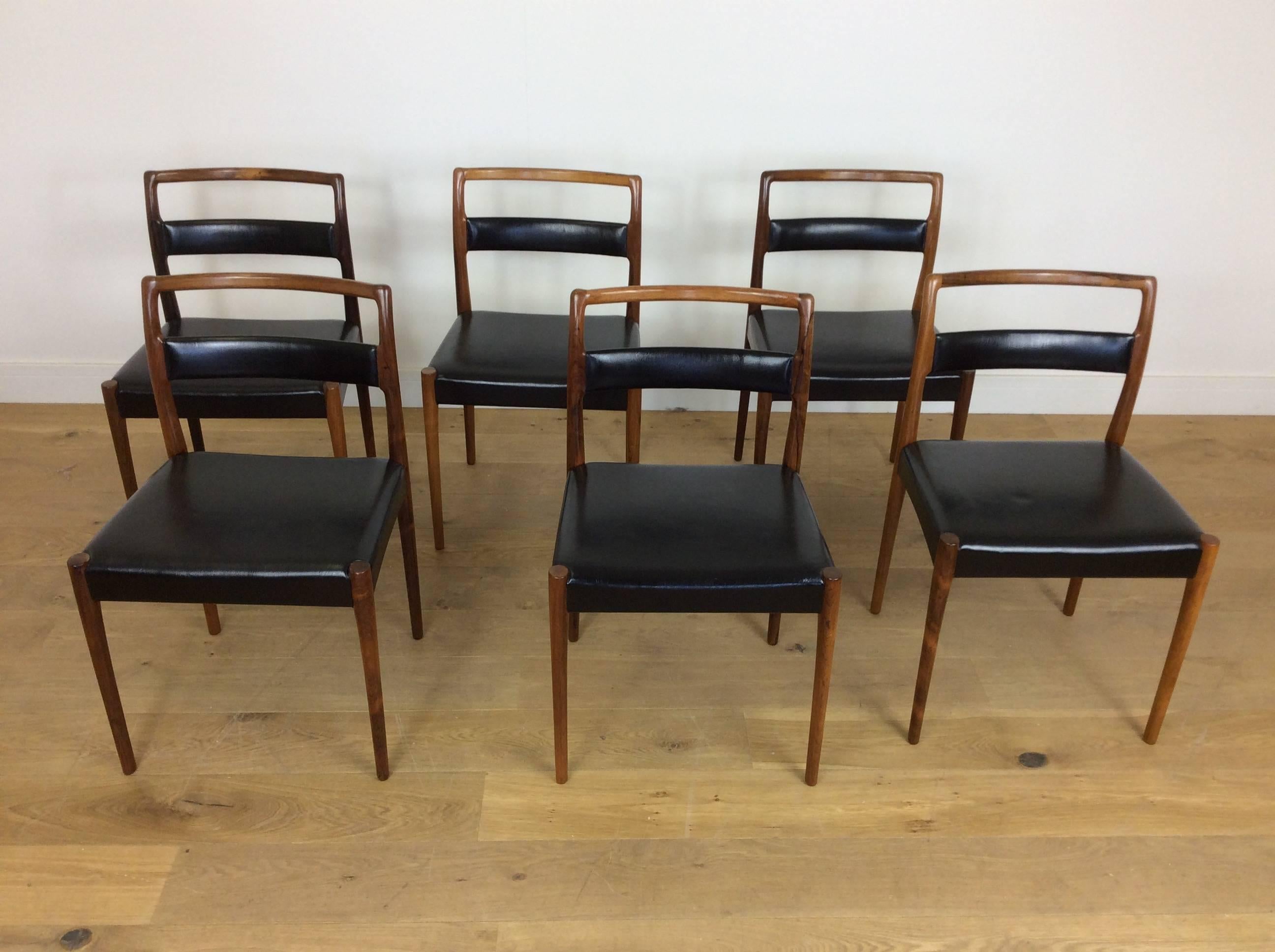 A set of six midcentury rosewood dining chairs.
Beautiful rosewood chairs with black vinyl upholstery.
Danish, circa 1960
Measures: 80 cm H, 49 cm W, 43 cm D.