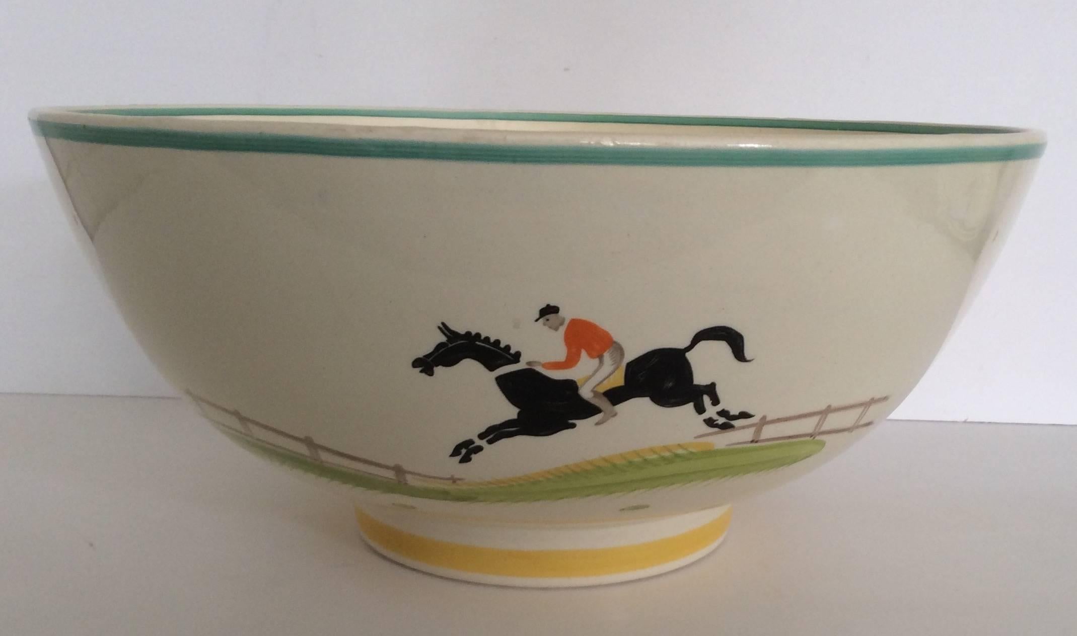 A large Susie Cooper punch bowl with a hand-painted design of horse and Jockey.
Susie Cooper hand-painted designs of this calibre are very rare and this example is offered in excellent condition.
Measure: HWD 14.5 cm, 31.5 cm, 31.5 cm,
British,