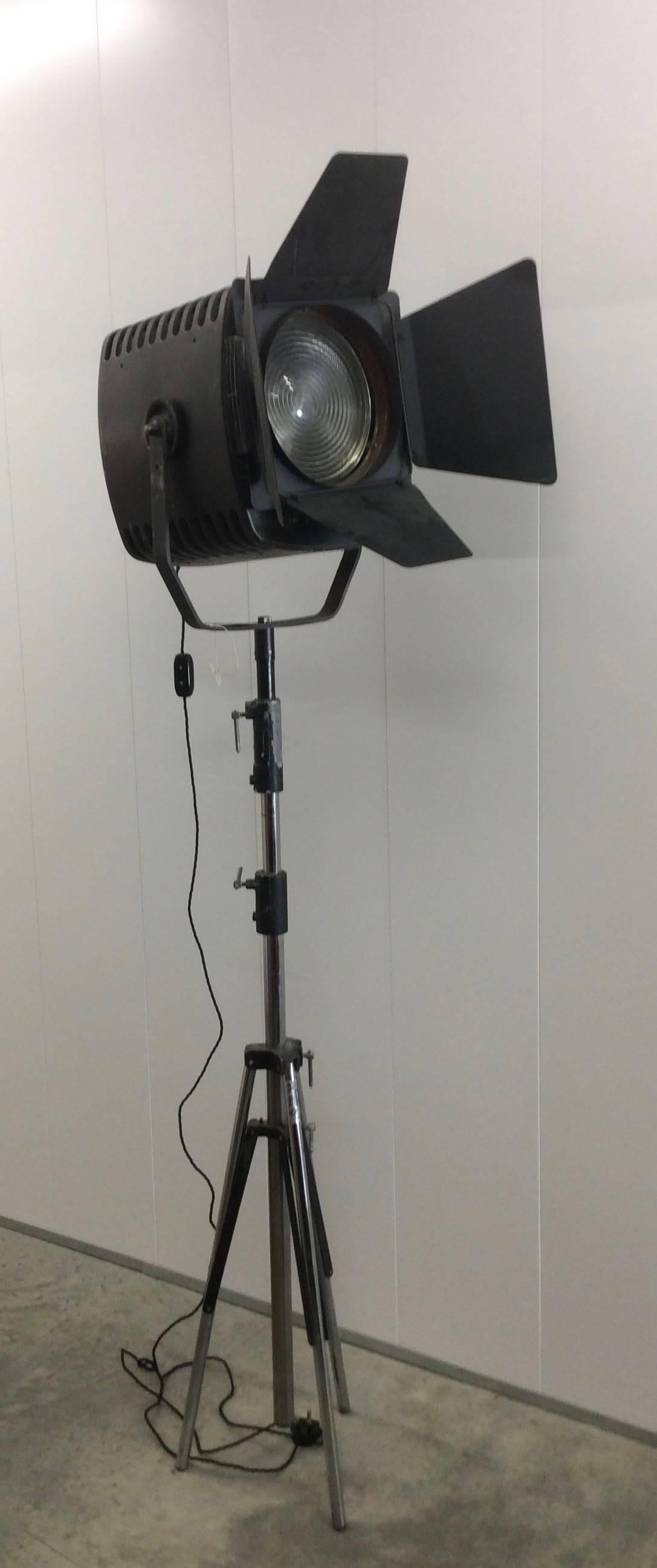 Vintage theatre light by Strand Electric, on telescopic tripod stand, black metal casing with adjustable slot in barn doors.
All re wired for domestic use with inline switch.
This vintage light has come from Rank Film Equipment
Measures: