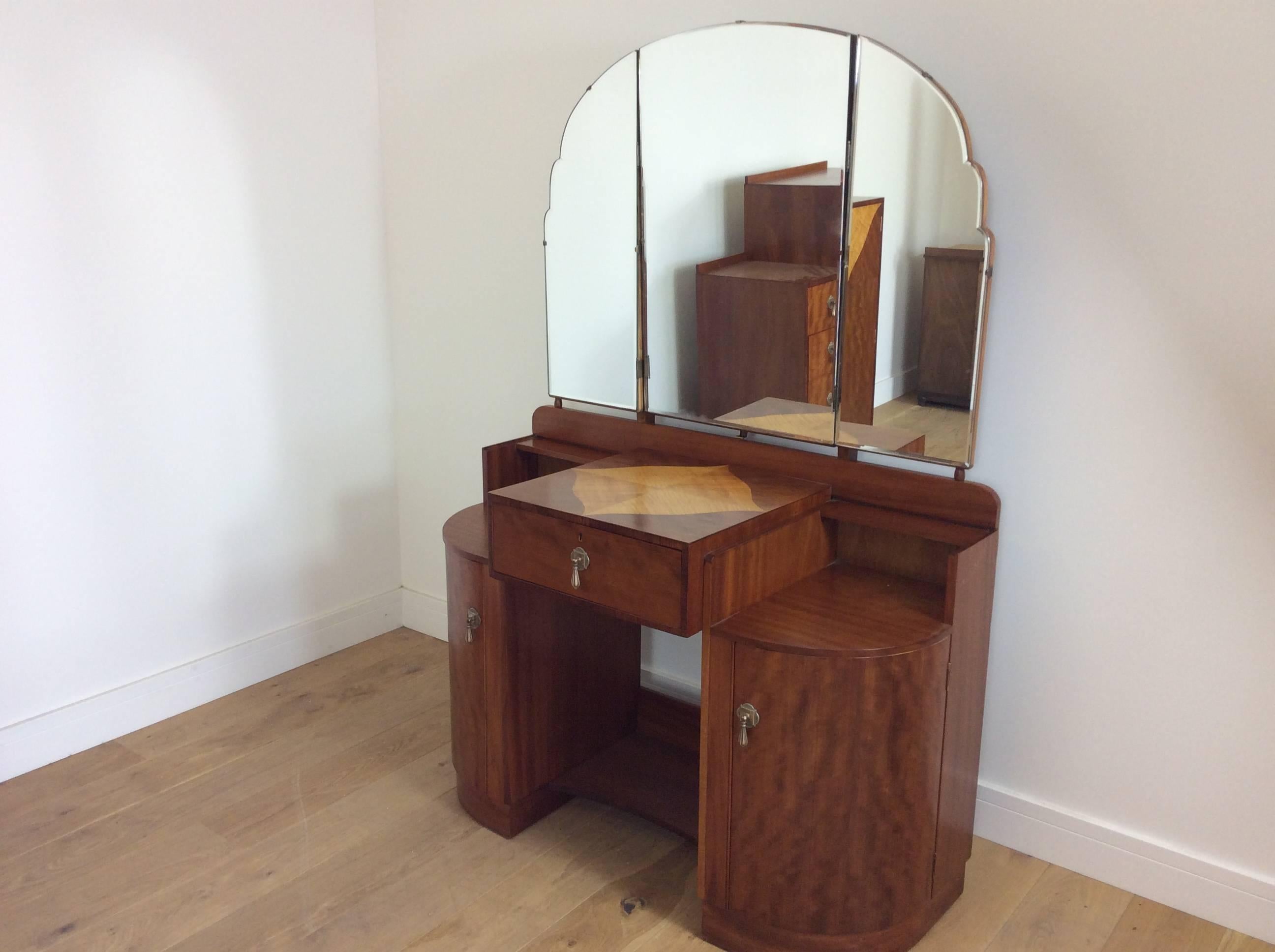 Art Deco bedroom set.
Art Deco bedroom suite, wardrobe, tallboy and dressing table by maple and Co, fine quality in satin walnut with satin maple detail and bronze handles.
Measures: Wardrobe 194 cm H, 122 cm W, 49 cm D
Tallboy 117 cm H, 84 cm W,