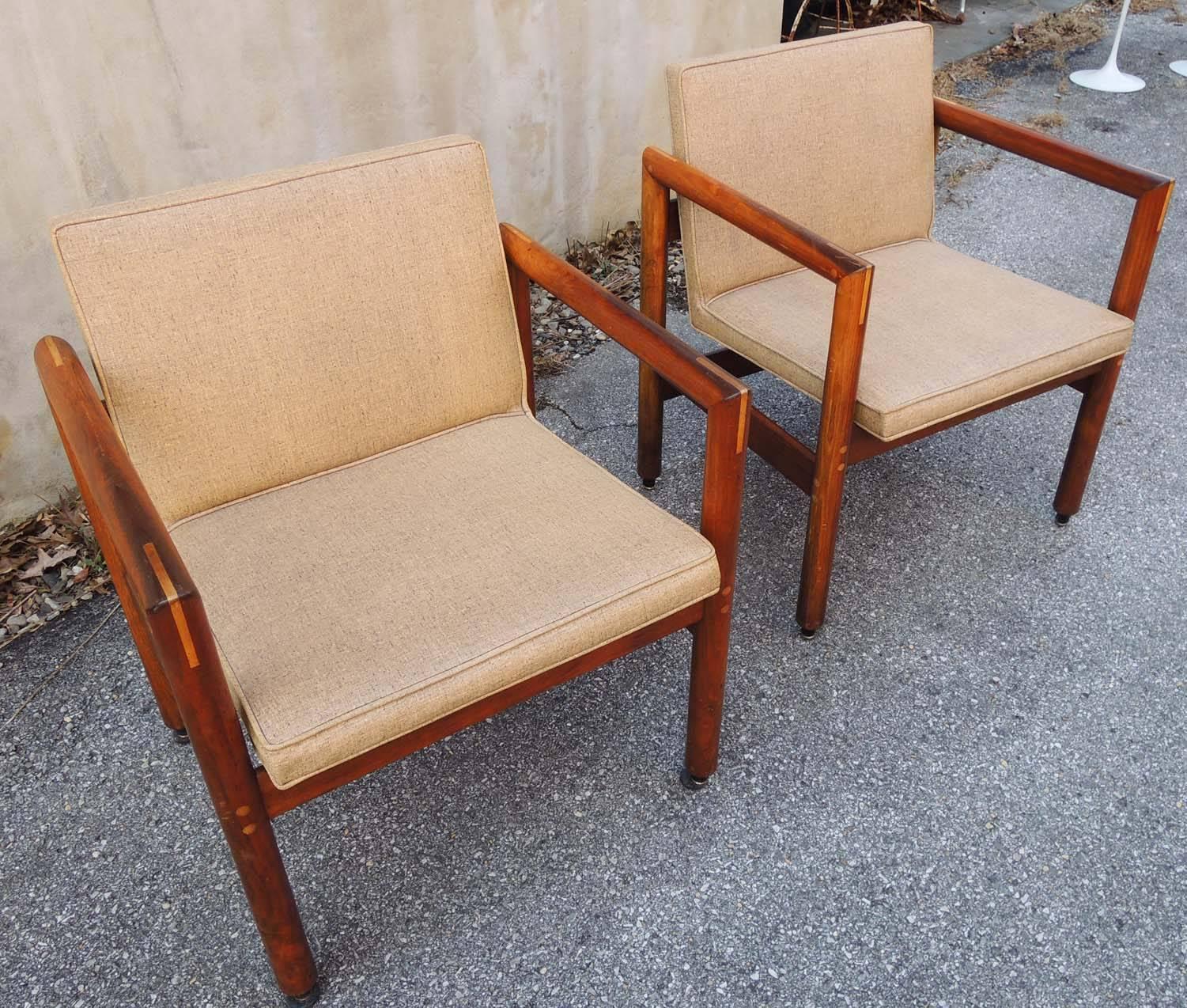 Unusual set of four armchairs, with original Thonet labels. Compact rectilinear design. Interesting details of contrasting wood details in arms and as screw covers. Original seat covers.