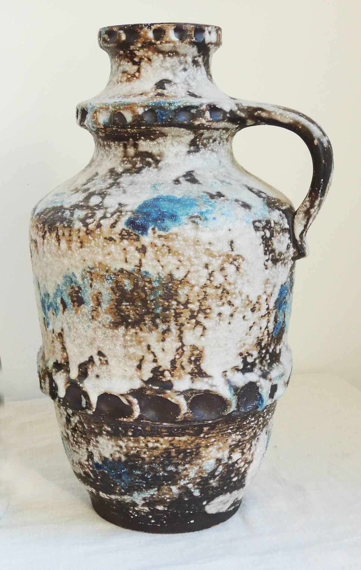 An imposing piece of sculptural ceramics, in the shape of a pitcher.
Great texture, color, incised details.
Marked on base.