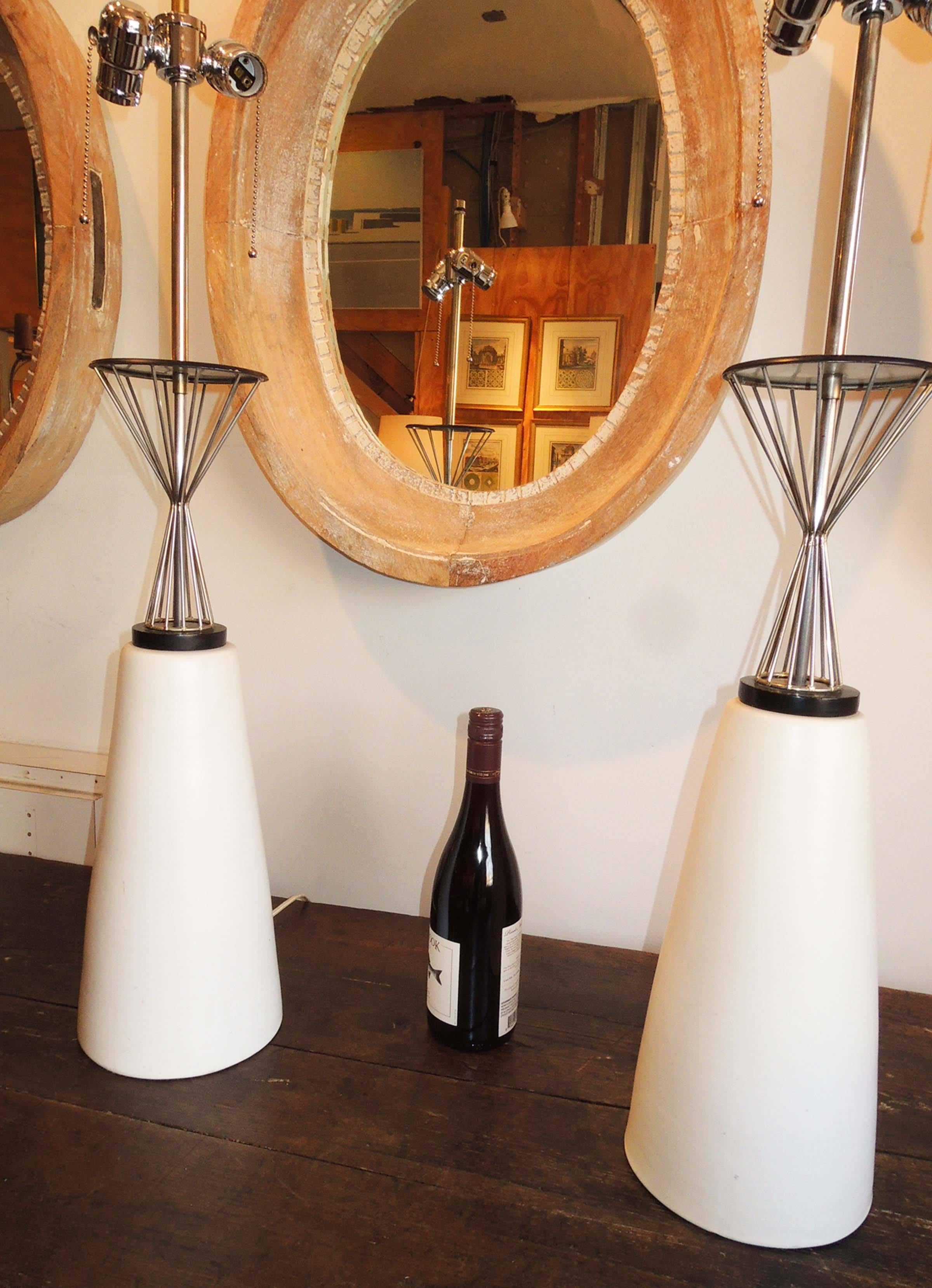 Pair of table lamps with white ceramic cone base topped by a steel corseted top.
Lamp base measures 20