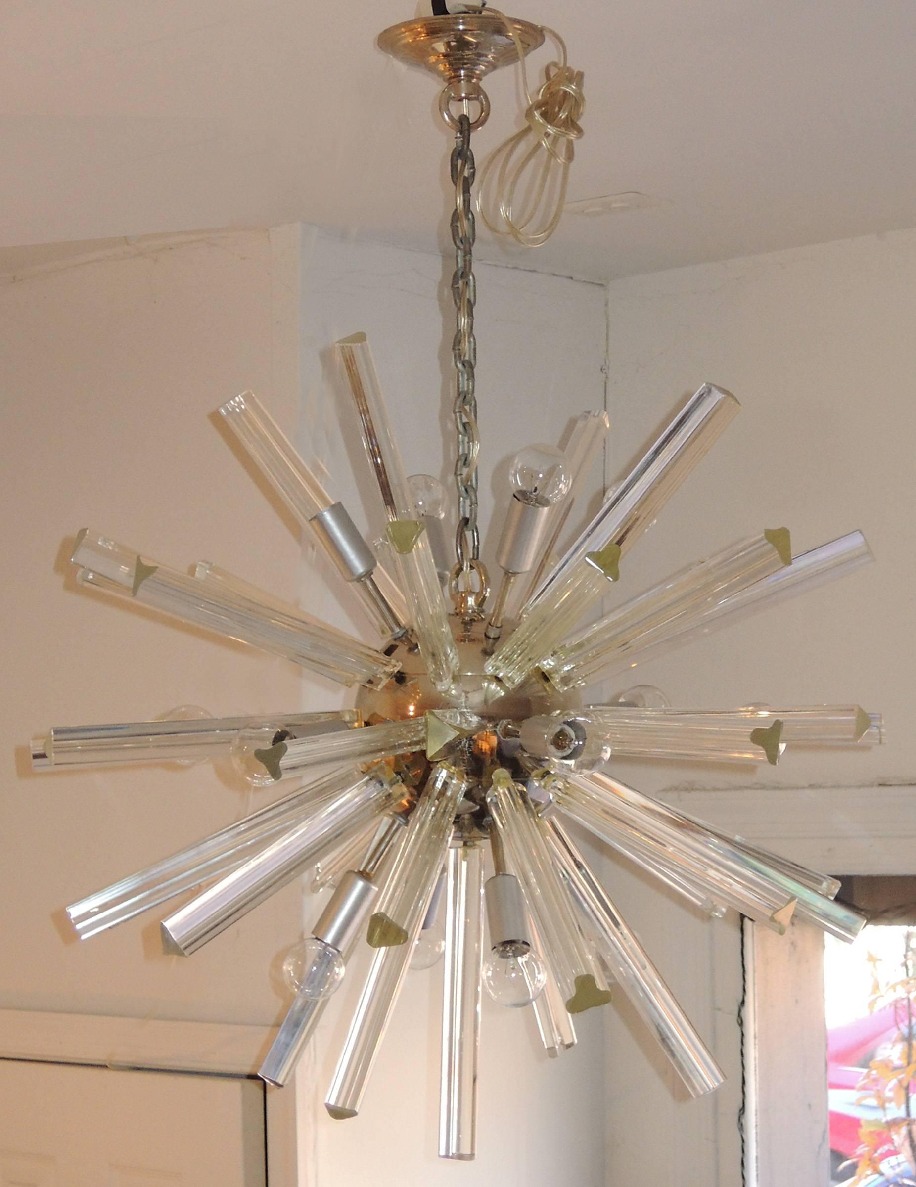 Period mid-century modern fixture with multiple Murano triedri glass rods emanating from a small polished chrome orb.
