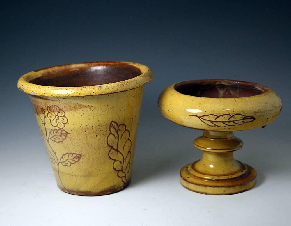 A rare and good size Fremington Pottery jardiniere with stand scraffito decorated through the honey colored slip with naive rendition of flowers.
Made by Edwin Beer Fishley (note a similar piece is inscribed with his name).
The red clay planter is