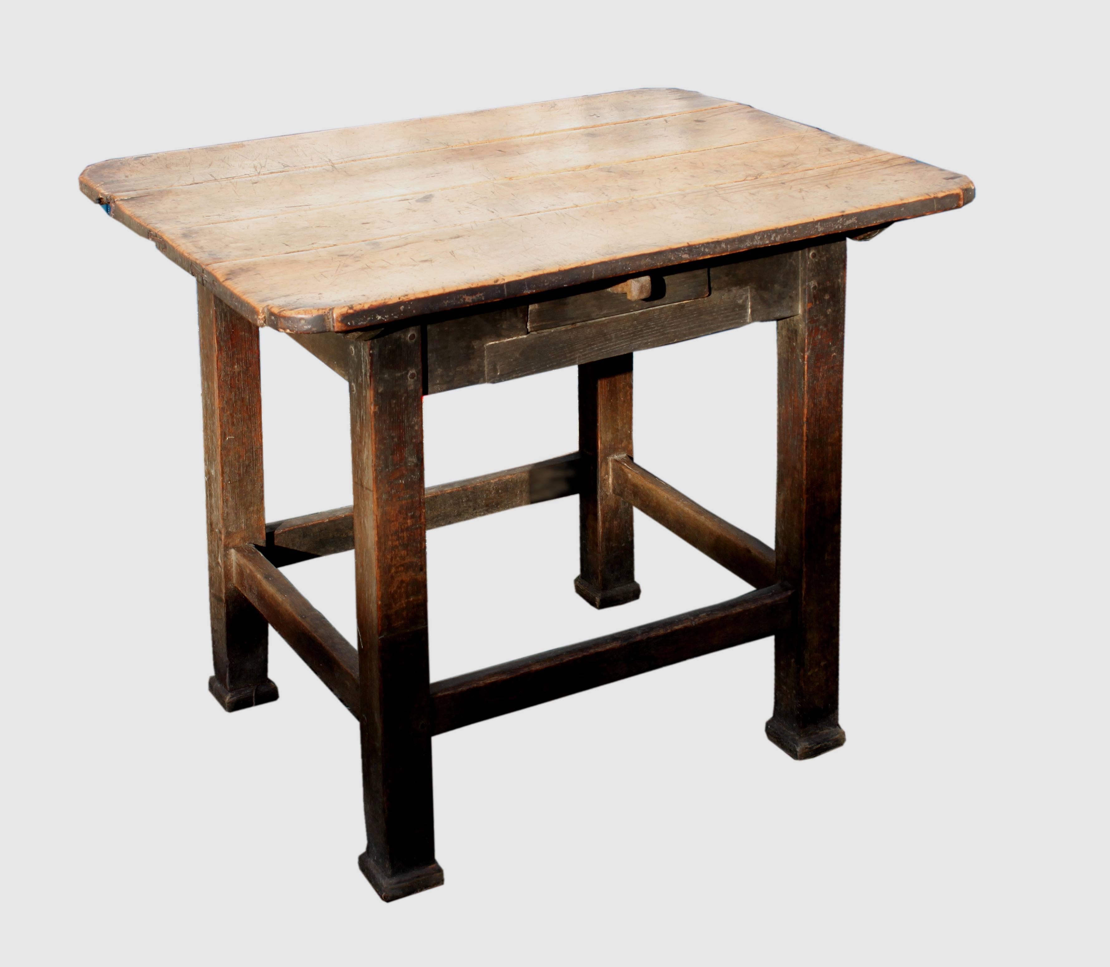 A Primitive early 19th century centre table with drawer; the top in fruitwood with quirk corners united to the oak base with sledge bearers, the base with peg construction, largely untouched condition.

 