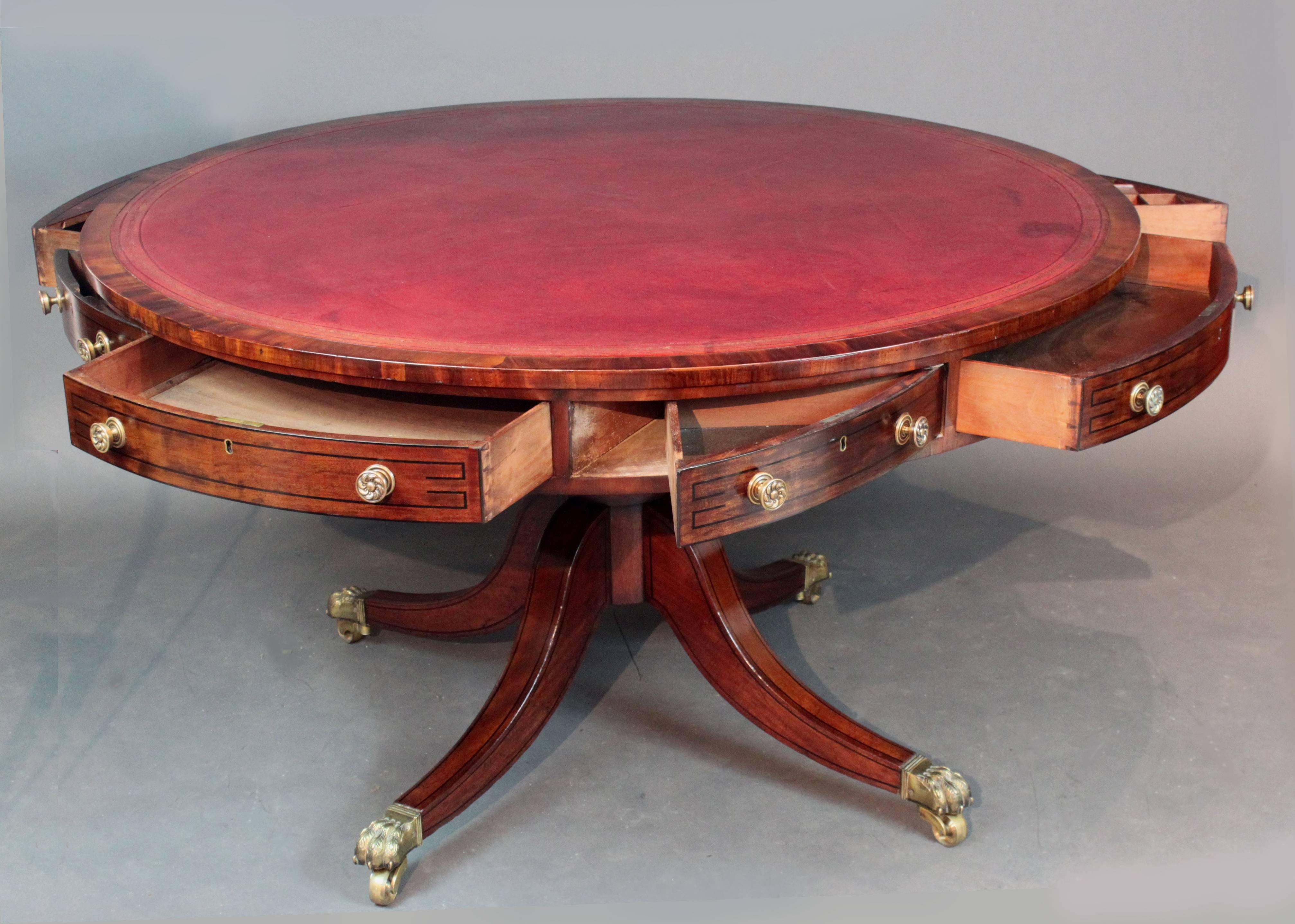 A good quality Regency drum table with ebony stringing to the top and the four-splay base; all eight drawers opening, including one drawer fitted for ink bottles and pens; the top revolves on the base,
circa 1815.


  