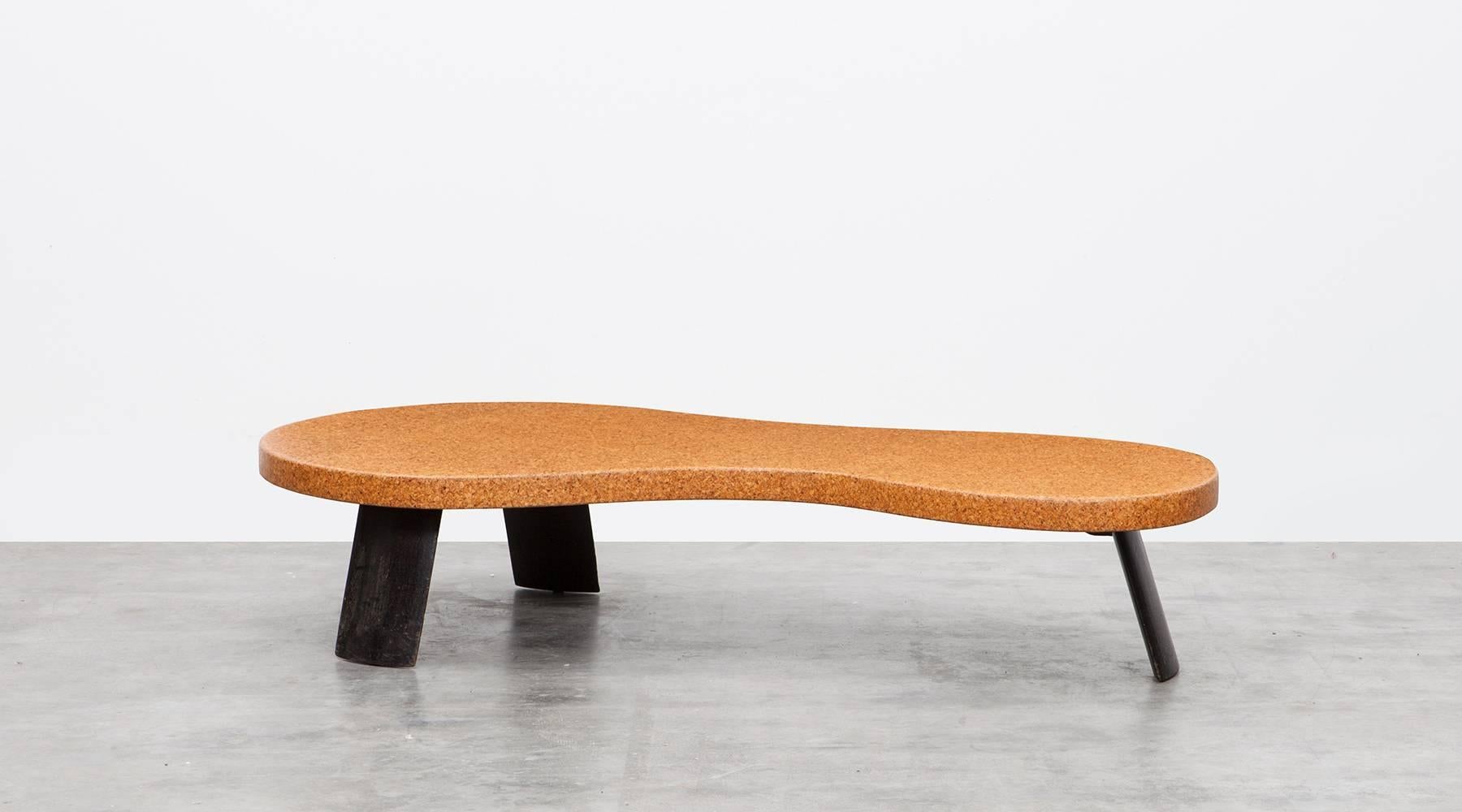 Midcentury coffee table designed by Paul Frankl. Eloquently shaped Tabletop out of cork, comes on three wooden mahogany legs. It can be used as a coffee table or a bench. Manufactured in 1951 by Johnson Furniture. 

Viennese Art Deco furniture