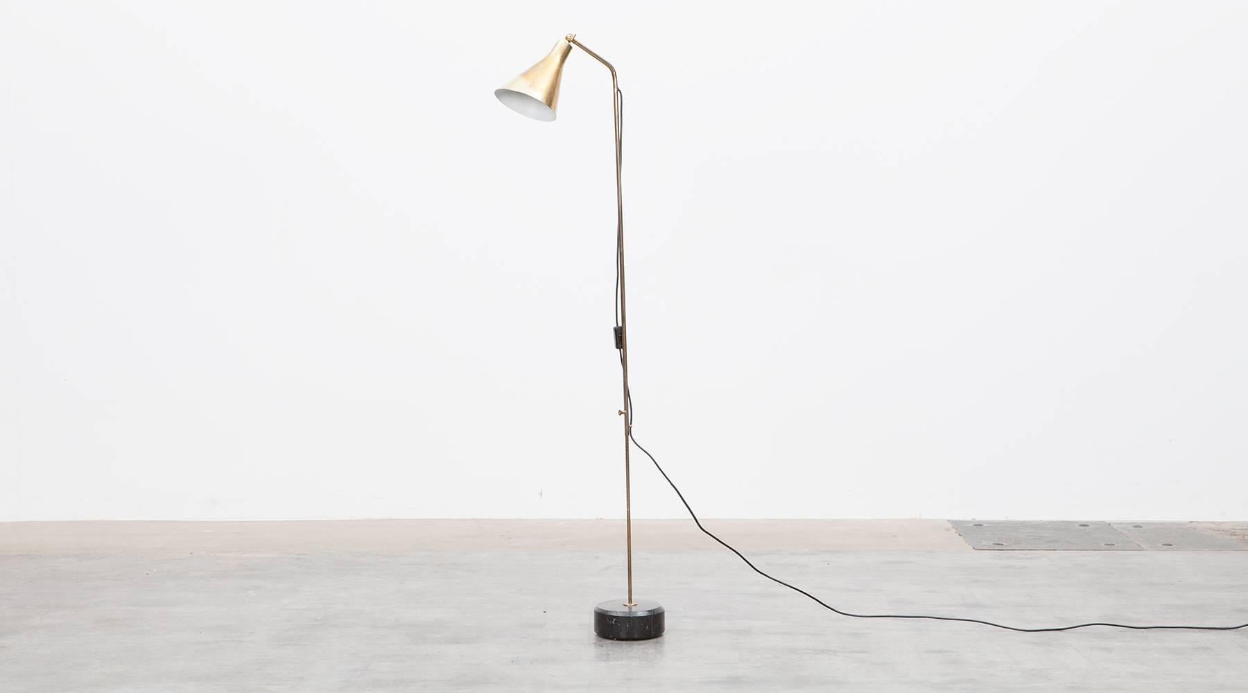 This lamp is a original and exceptional pieces. The first iteration of this lamp was designed by Ignazio Gardella in 1948. The Floor Lamp is adjustable in height as well as at the shade, which gives a warm and pleasant light . Its solid base is a