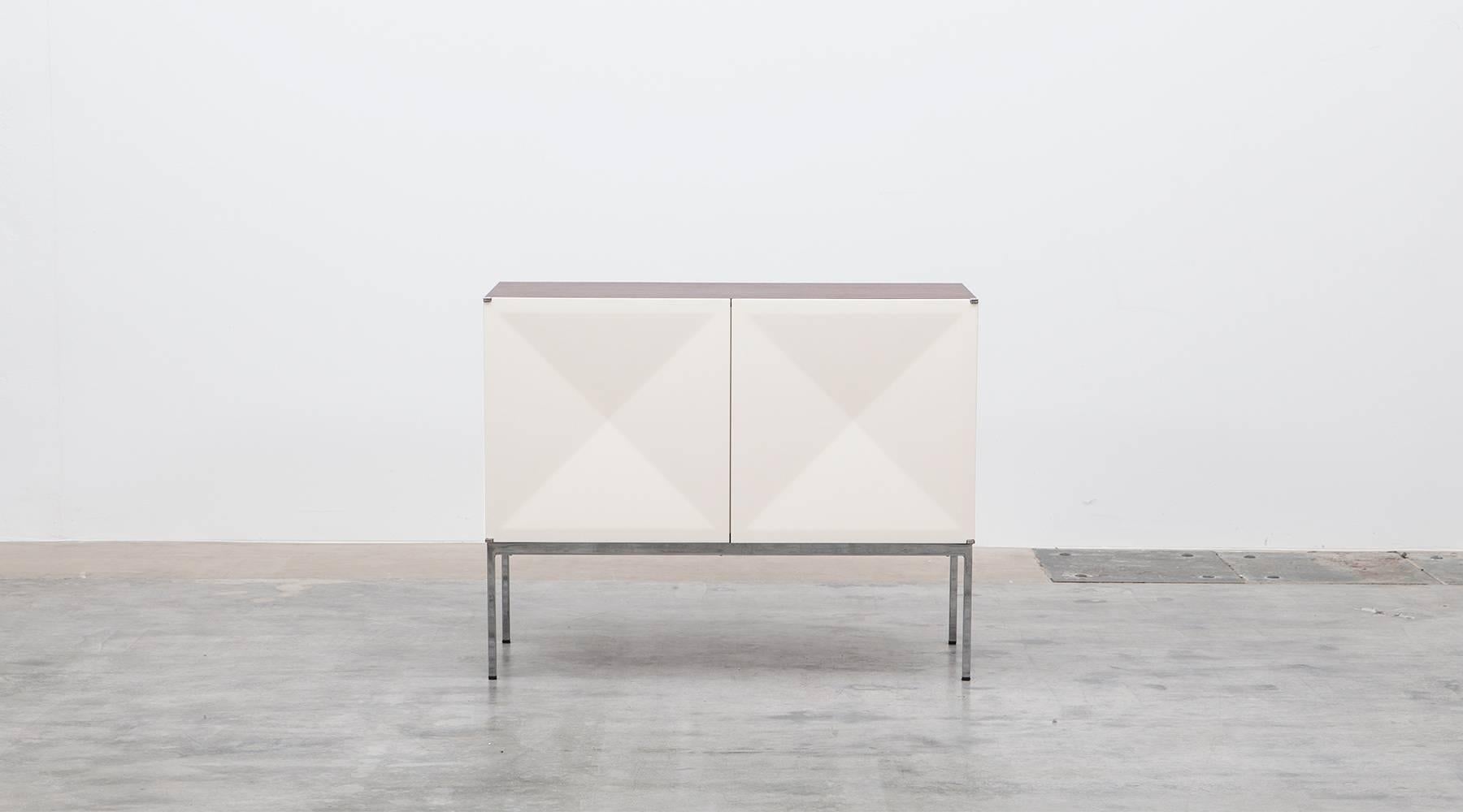 Sideboard with white lacquered diamond shaped doors designed by Antoine Philippon and Jacqueline Lecoq. The corpus is mahogany, the inlay in maple features a big storage area with shelves on one side and four drawers on the other side. Manufactured