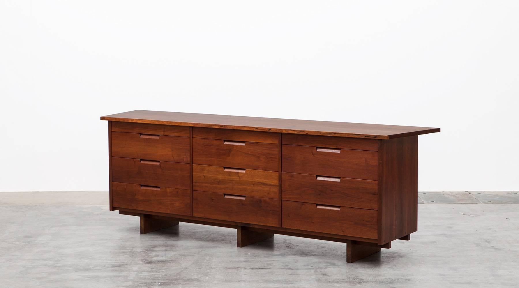 Handcrafted sideboard designed by famous American George Nakashima. It is constructed with American black walnut and contains nine drawers with sufficient storage space. Graceful in proportion, it is one of the great examples of Nakashima's