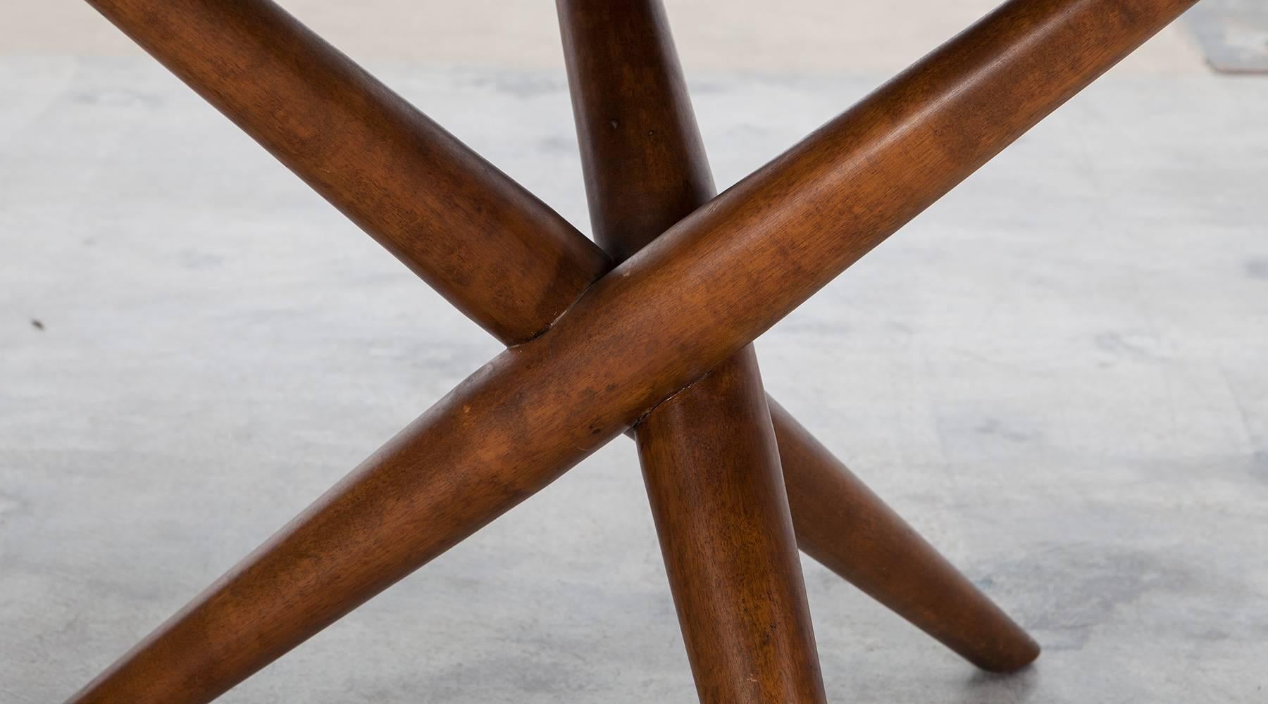 Sculptural Side Table in walnut designed by T.H. Robsjohn Gibbings. Very sculptural splayed tripod form, yet strong and sturdy. It is a versatile size and could be used as a side or night stand or coffee table. These are one of Robsjohn's signature