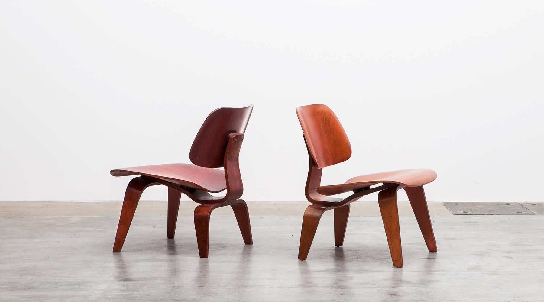 Molded plywood in red, brown LCW Chairs by Charles and Ray Eames, USA, 1948.

A set of Charles and Ray Eames 