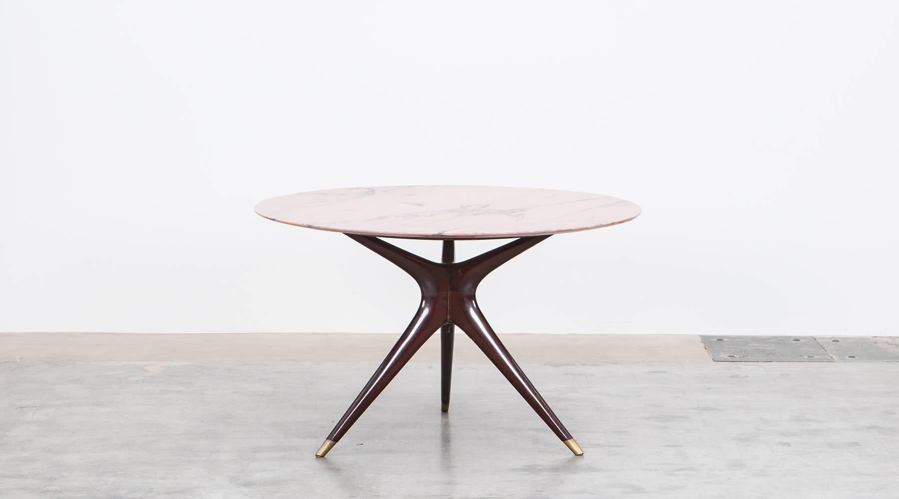 Beautifully worked table designed by Ico Parisi comes with round table top made of finest marble. The three legs are made of wood and finish on brass. Manufactured by Ariberto Colombo.

The creative multitasker was not only one of the most important