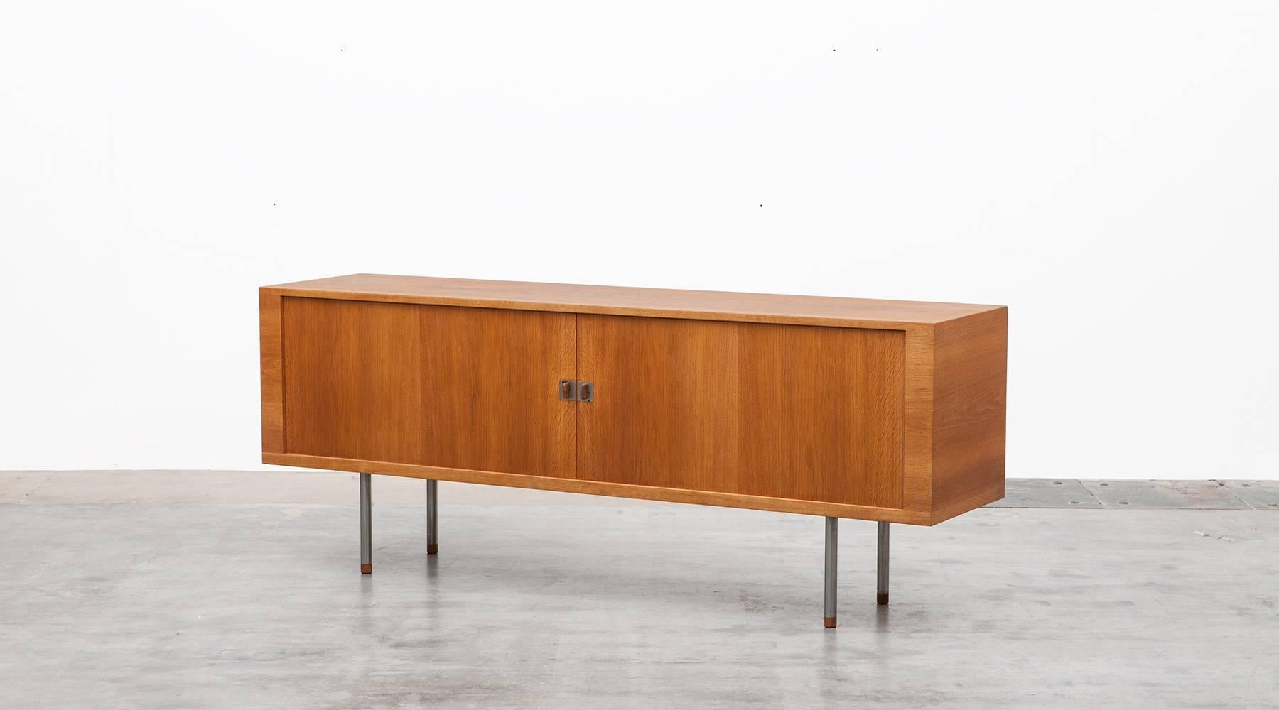 Sideboard designed by Hans Wegner in oak with tamboured doors and metal legs. inlay contains a lot of storage space and four drawer trays in the middle section. Manufactured by A/S Ry Mobler. On the surface there is a mark in the veneer, it can be