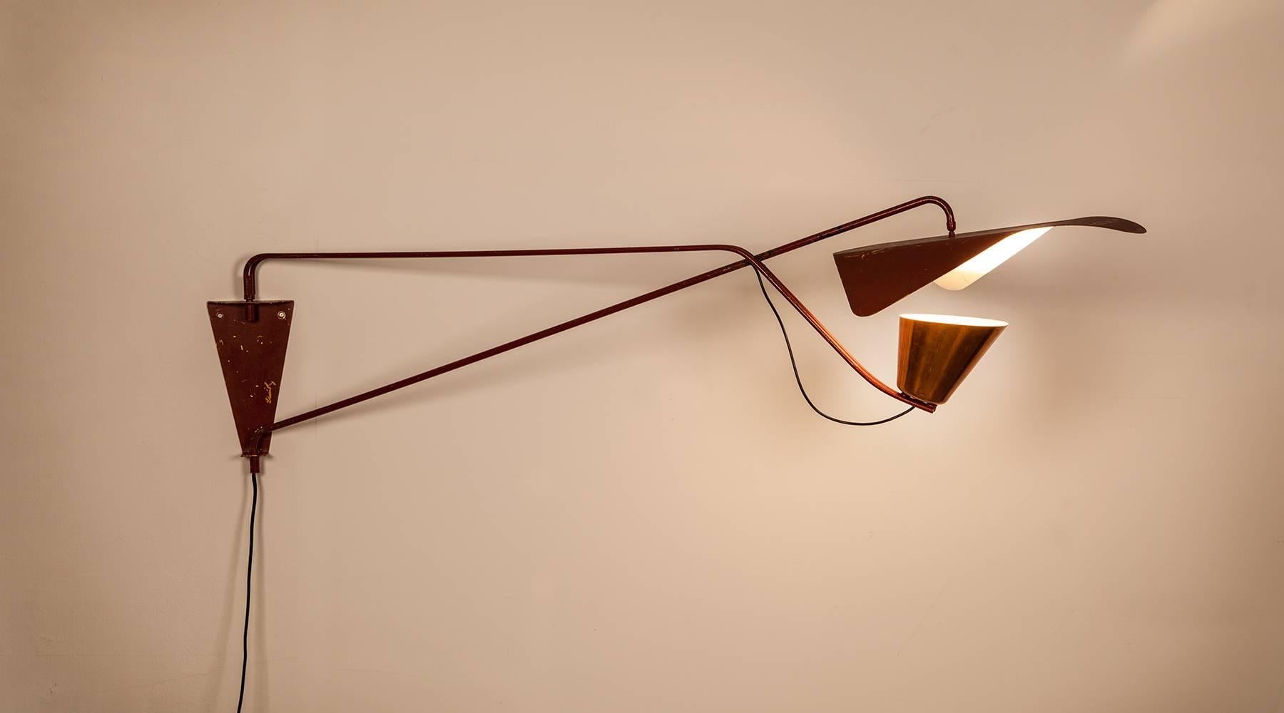 Rare wall Lamp from 1953 in red lacquered metal and copper designed by Willy Van Der Meeren. The adjustable swing arm goes together with the lampshade and with the reflector lacquered on the inside in white which spreads a beautiful warm light. The