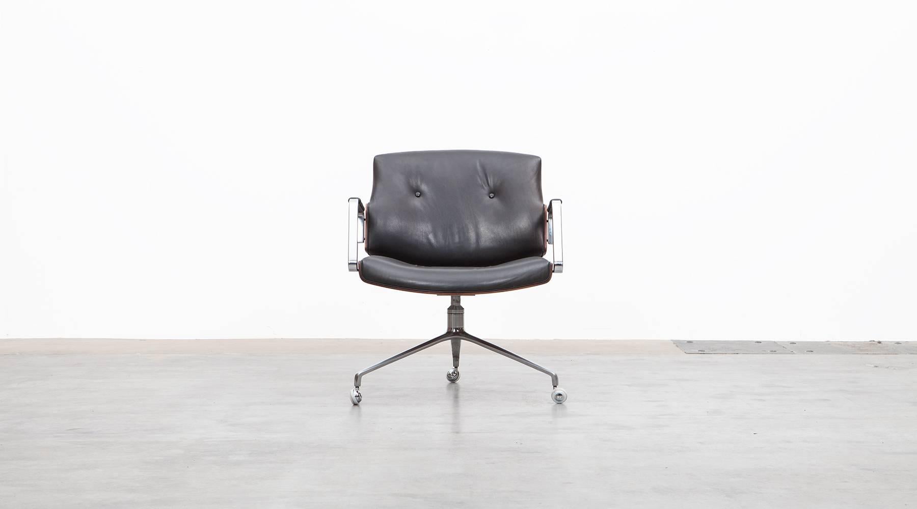 Black leather, wood, Swivel Chair by Fabricius and Kastholm, Germany, 1968.

Classical Swivel chairs designed by Preben Fabricius and Jørgen Kastholm. The chair has a brushed steel tripod foot, high quality leather upholstery and two curved wooden