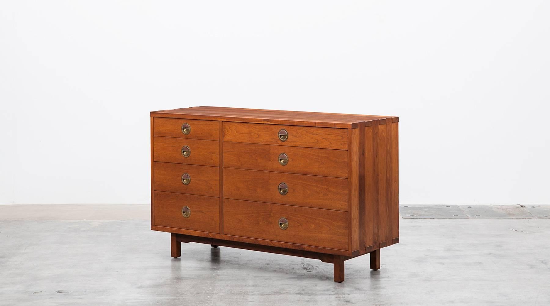 Very rare Edward Wormley Sideboard comes in walnut and a very high quality finish. It contains eight drawers in two different sizes, the grips are made out of brass. Manufacturer's label inside. Manufactured by Dunbar.