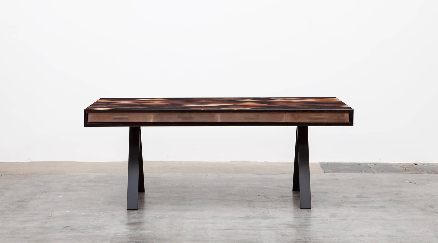 Desk by contemporary German artist Johannes Hock, veneered table top in diamond pattern, 30 types of wood. Drawer front in bronze. Under one of the diamond pattern is a hidden access to electricity and this pattern can be exchanged in everyone’s