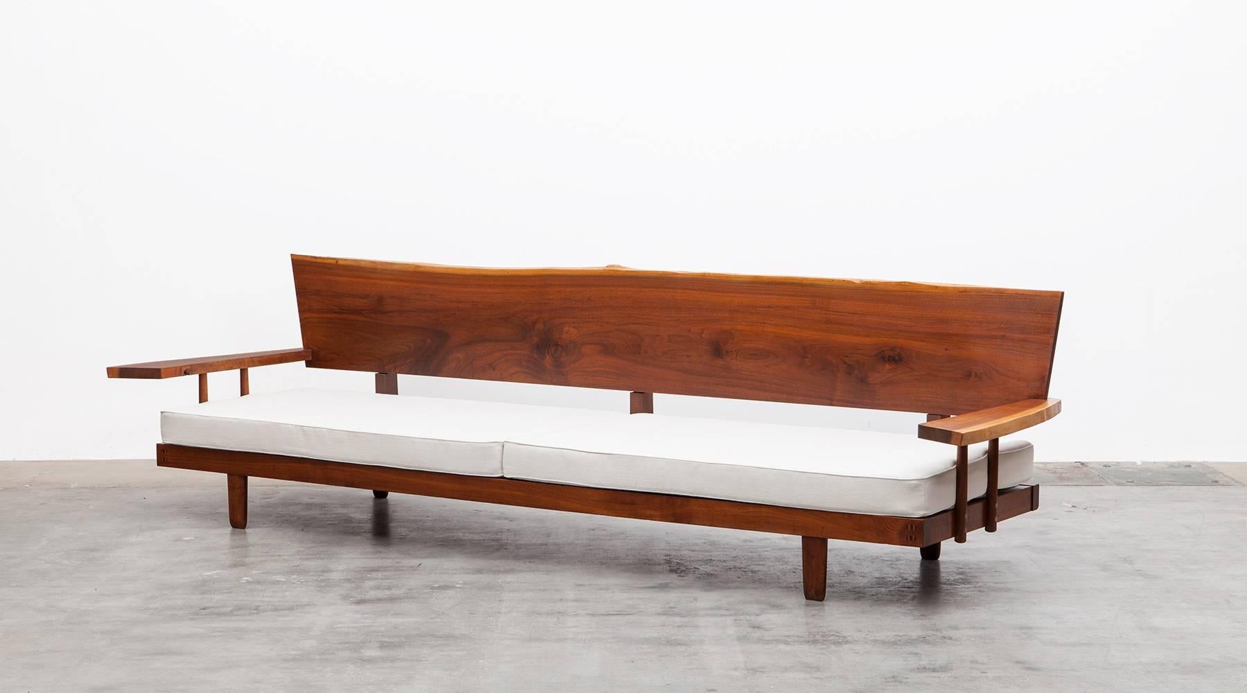 Handcrafted, stunning, marvellous sofa. It is constructed with American walnut with handwork by George Nakashima himself. 

By that, its being a great example of Nakashima's outstanding, delicately proportionated woodwork. The Architecture alumni