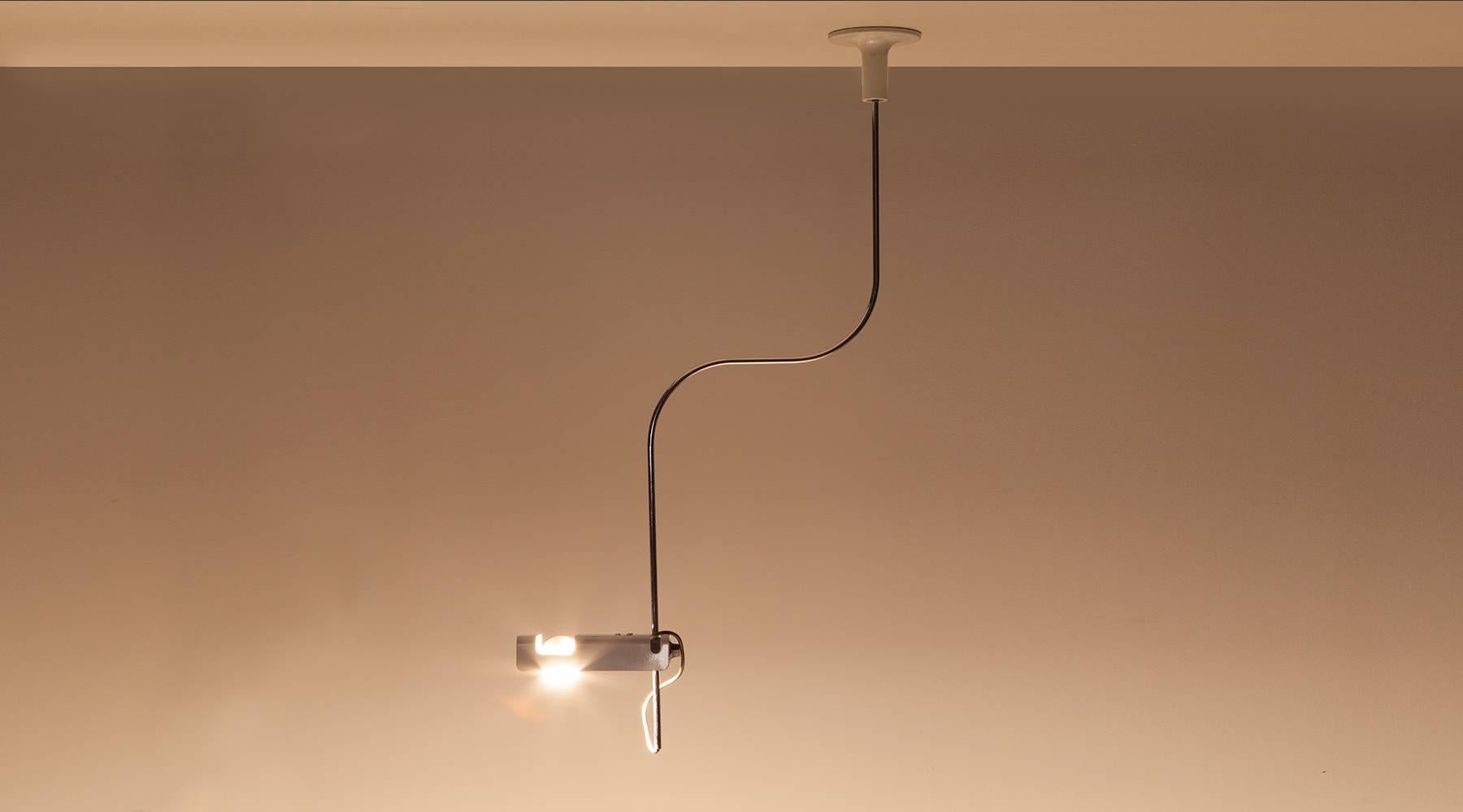 This filegree and versatile ceiling lamp was designed by Joe Colombo in 1967. It is made from white lacquered, chromium plated steel and metal. The lamp is adjustable to the shade and can be fixed to the ceiling. Manufactured by O-Luce. 

The