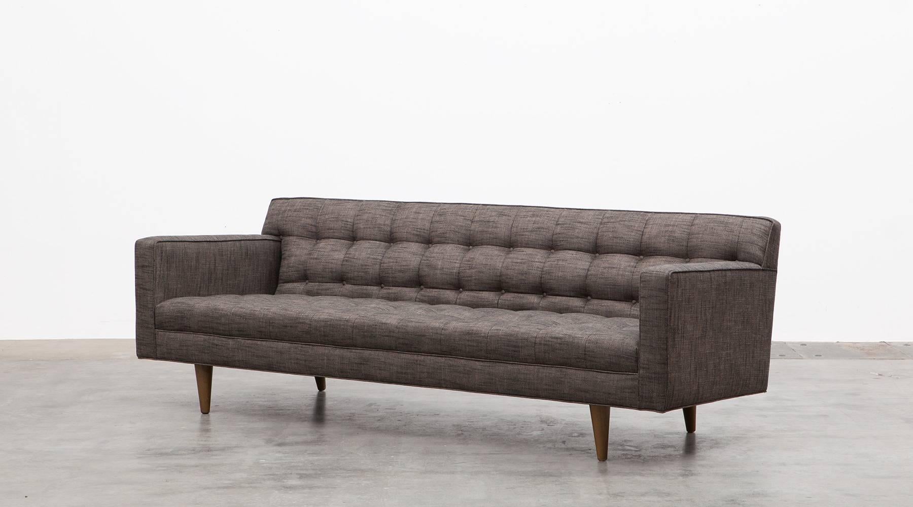 This classical three-seat sofa is designed by famous Edward Wormley. It is newly upholstered with high-quality fabric and stands on wooden feet. It’s simple but stunning design makes this sofa to a very unique and special item and promises a very