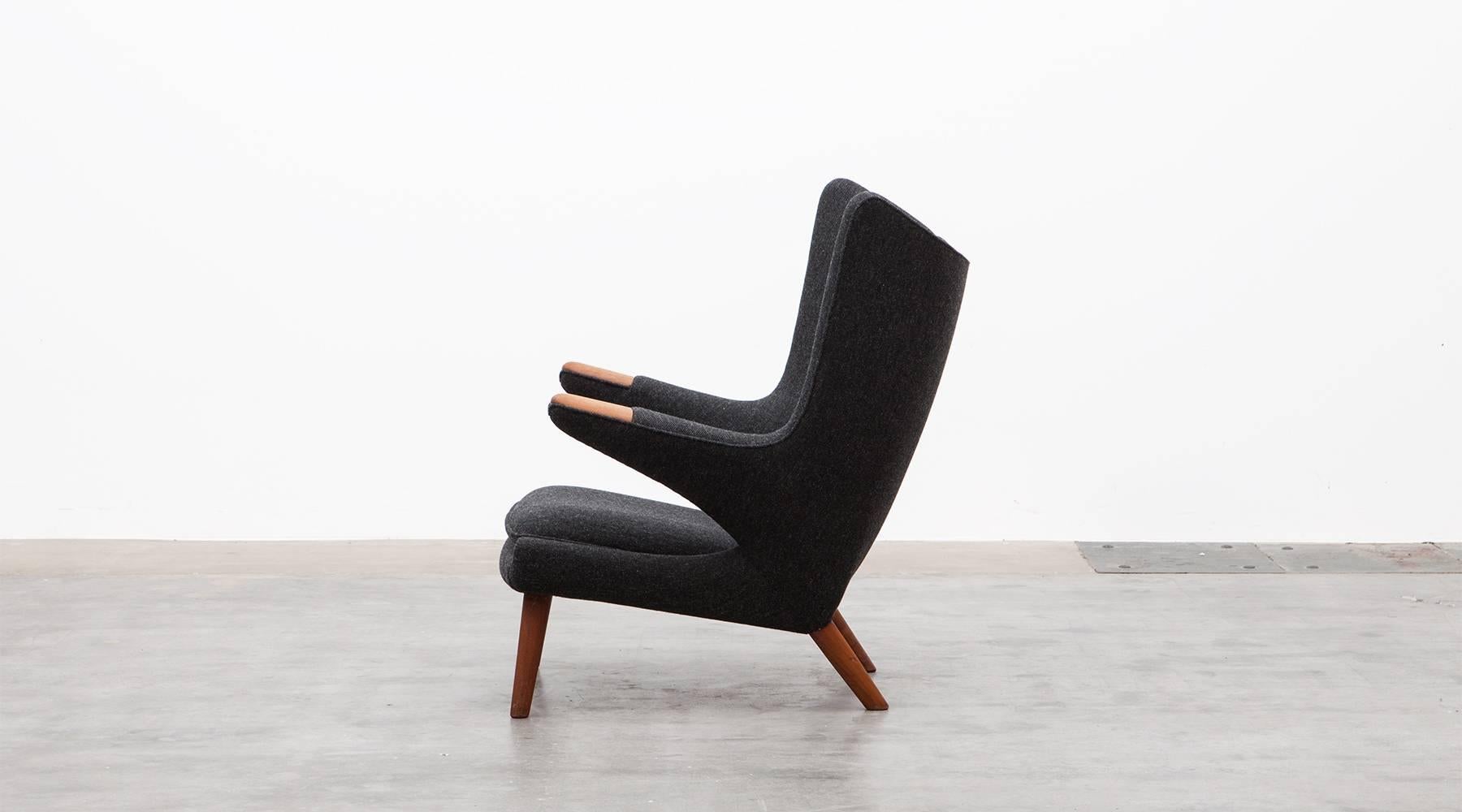 Wonderful original Papa Bear lounge chair designed by Hans Wegner. It is in perfect condition and newly upholstered in dark gray high-quality woolen fabric. The legs and nails are solid wood and recently reworked. Manufactured by A.P. Stolen.