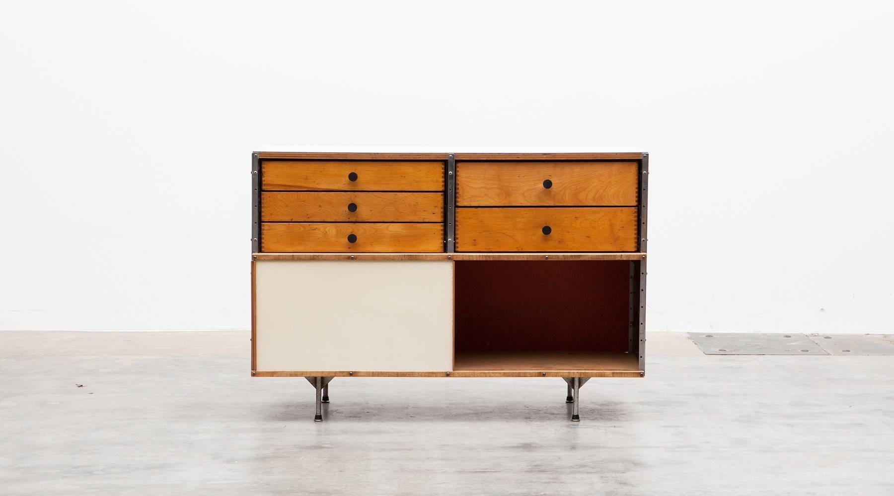 Charles and Ray Eames storage unit featuring five drawers in two different sizes and two sliding doors. Side and back panels feature the sought after primary color combination of red, blue, yellow and white. The shelf comes in good original