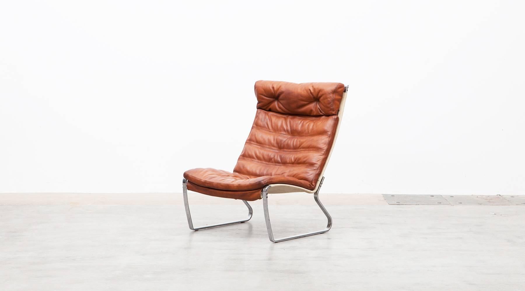 The seat and back of this armless easy chair is covered in orange leather and designed by Jørgen Kastholm. The chair is wide and inviting, tremendously comfortable. Manufactured by Kill International.

Together with fellow Scandinavian Design legend