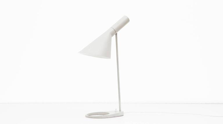 Classical grey desk lamp in steel with original lacquering designed by Danish Design icon Arne Jacobsen. Angle of shade can be adjusted to optimize light distribution. 

Manufactured by Louis Poulsen. Alongside succesfull furniture design for Fritz