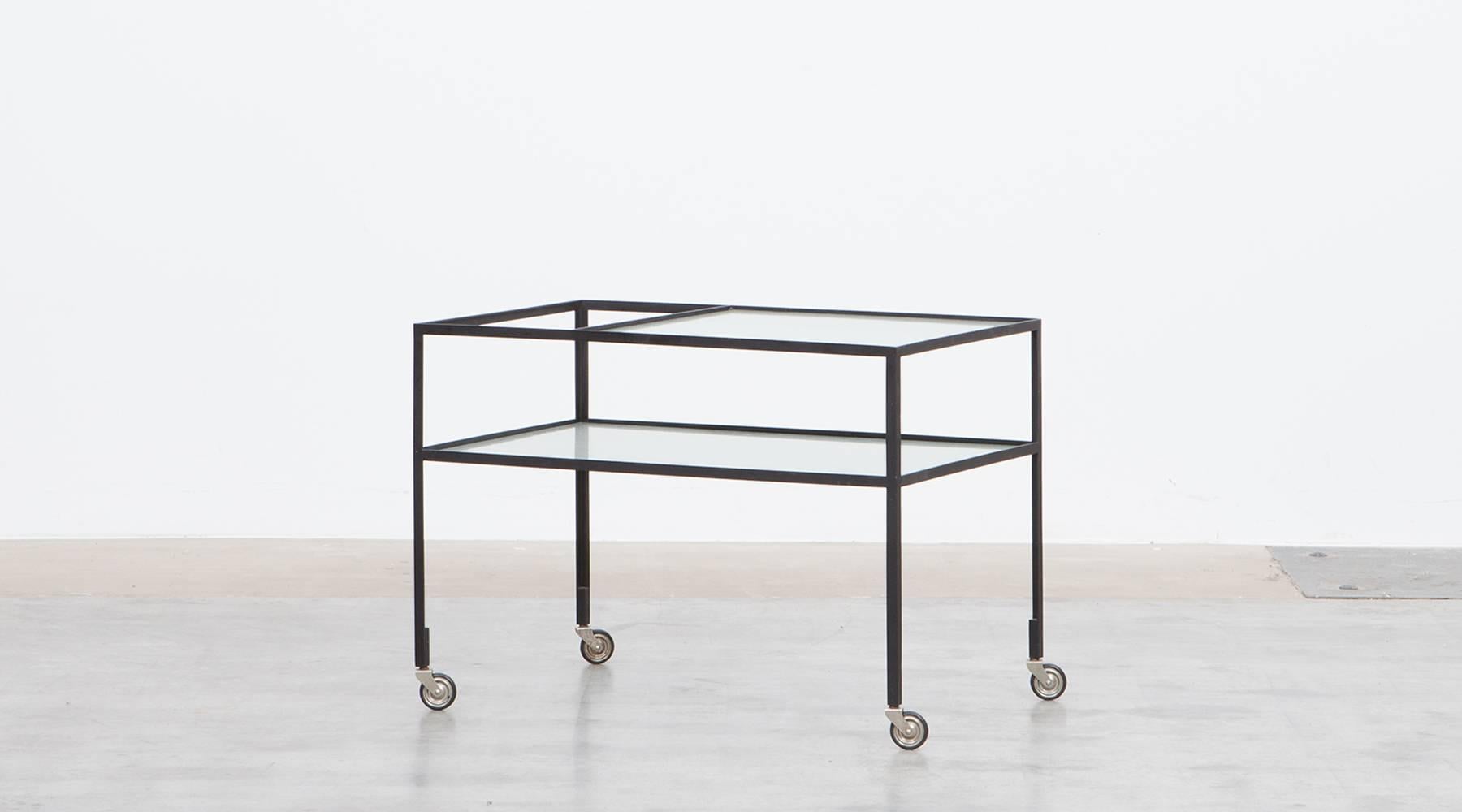 Slender Serving Cart in steel with original reeded glass plates is designed by German architect Herbert Hirche. The slender and reduced steel frame holds the very well-preserved original glass plate. Manufactured by Christian Holzäpfel KG. 

Bauhaus