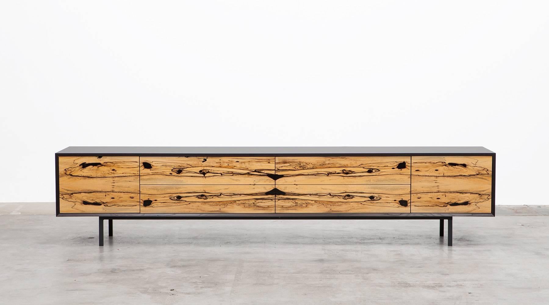 Sideboard by contemporary German artist Johannes Hock. The front of the doors and drawer of this unique piece are made of high-quality white ebony, the corpus is in black hpl on black metal legs. Manufactured by Atelier Johannes Hock.

Hock refined