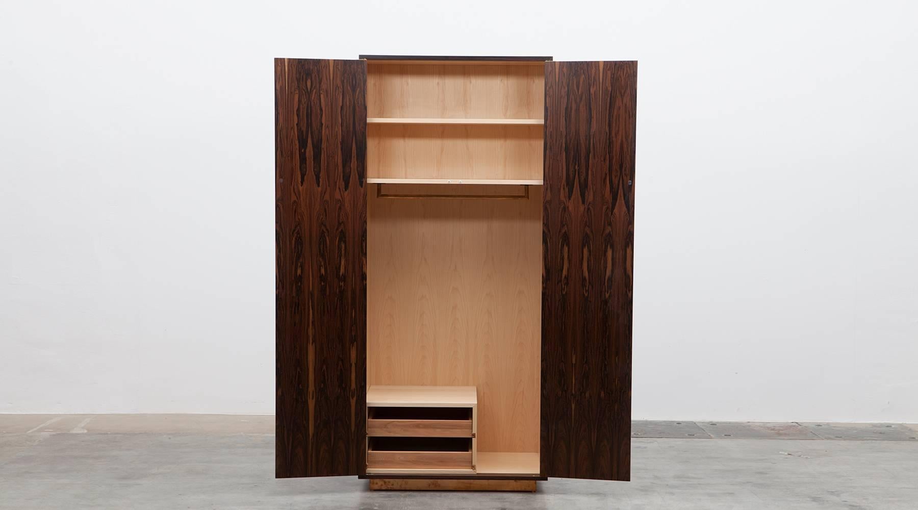 Cabinet by contemporary German artist Johannes Hock, veneered door top in diamond pattern, 30 types of wood. The cabinet contains space to hang clothes as well as add it to the shelfs or two drawer. Matching pair of nightstands available.