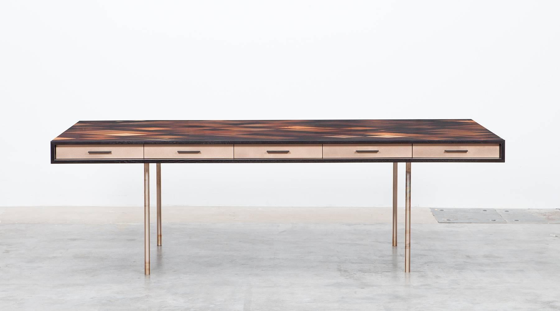 Desk by contemporary artist Johannes Hock, veneered tabletop in diamond pattern with thirty different types of wood. Five front drawers in bronze. Hidden access to electricity under the pattern which can be adjusted to personal taste. Similar