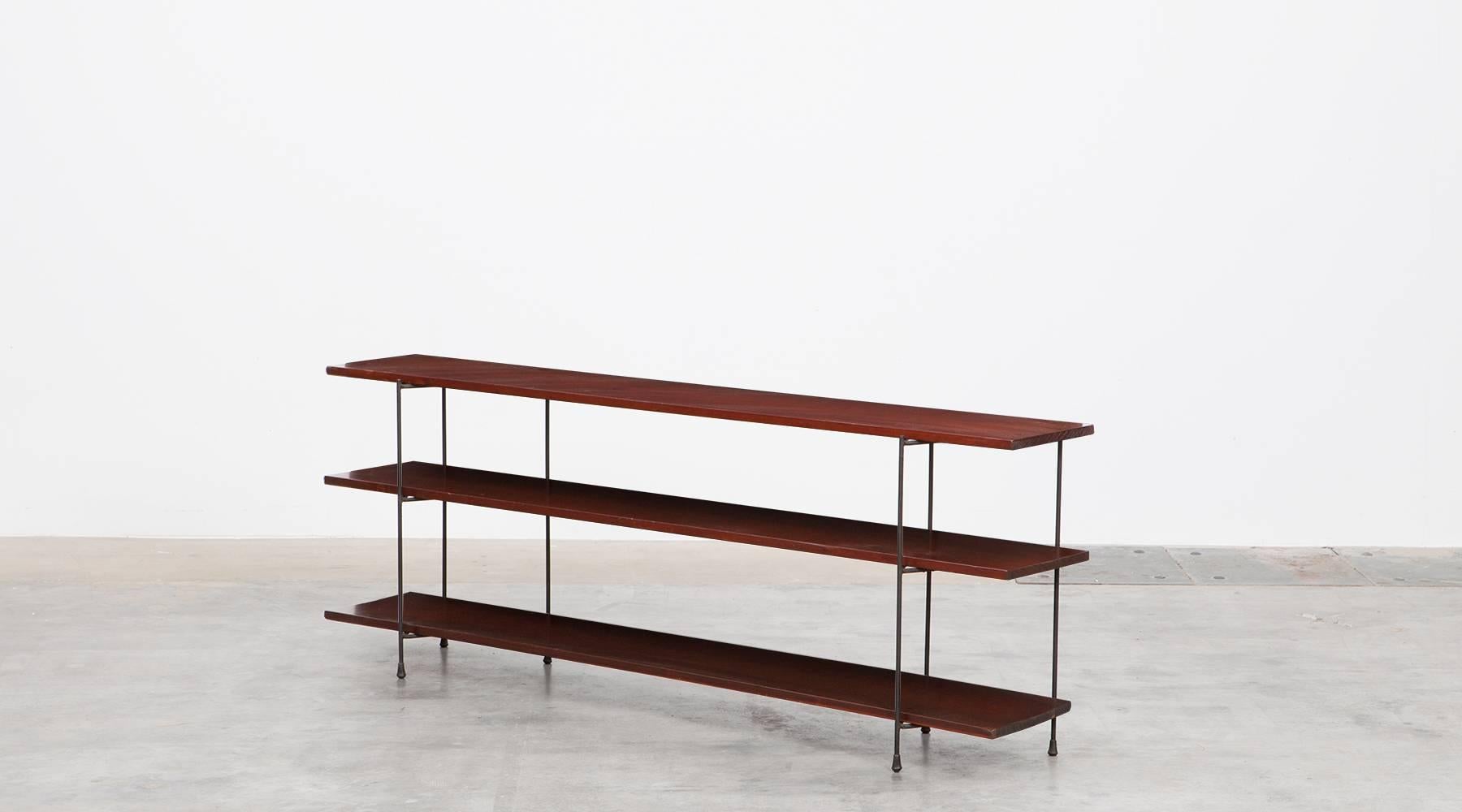 Minimal and solid shelf in a classic mid-century modern style. ​The three pales of the shelf are made of stained pinewood in black lacquered metal base. The reduced, thoughtful lines equal the style of Luther Conover. The shelf comes in good
