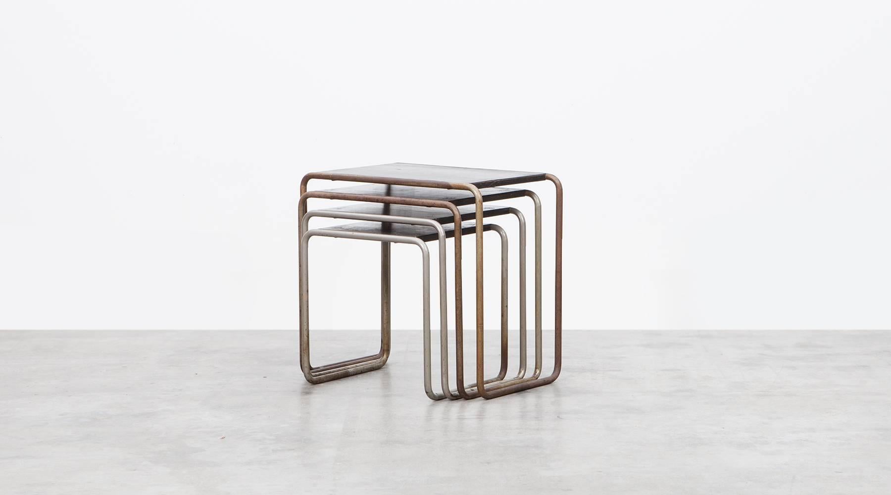 Set of four nesting tables made out of black lacquered stained wood on chromium-plated steel base. The set is designed by Marcel Breuer, who was the inventor of the modern steel tube furniture. Manufactured by Thonet.

All are 40 cm deep and height