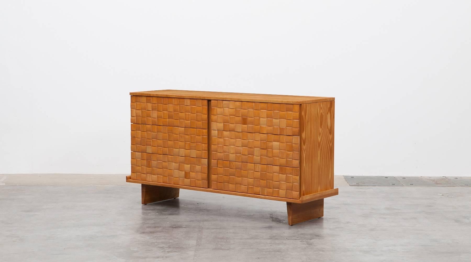 Handsome ash cabinet designed by Paul Laszlo features six of his basket weave drawer fronts and modern shaped legs. The sideboard comes in very good original condition, professionally reworked by our workshop. Manufactured by Brown Saltman.

The