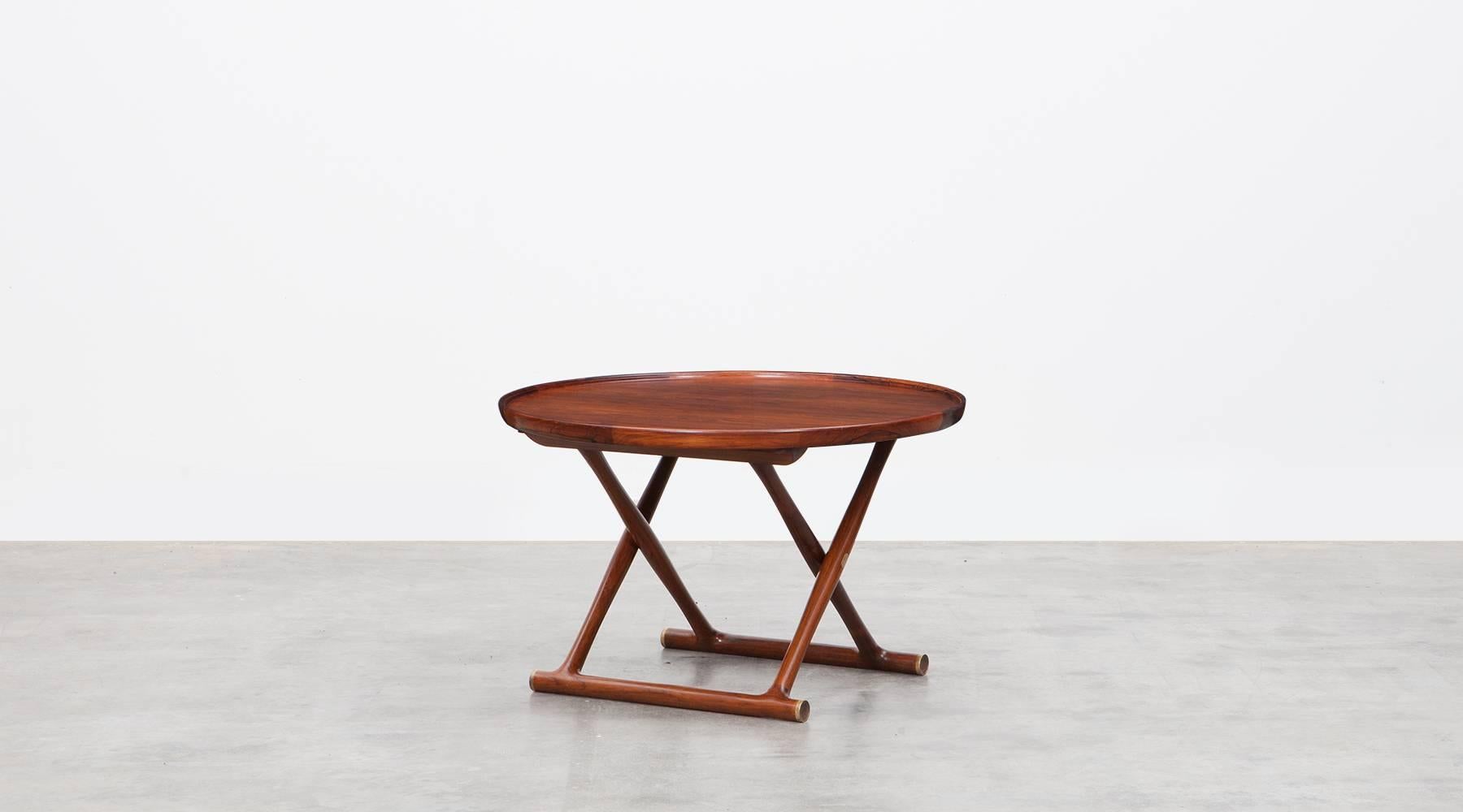 Circular occasional table designed by Mogens Lassen in mahogany with brass details and fittings. Elegantly designed and beautifully made in rosewood. Table folds for storage. Manufactured by A.J. Iversen.

Nanna Ditzel was a Danish jewellery,