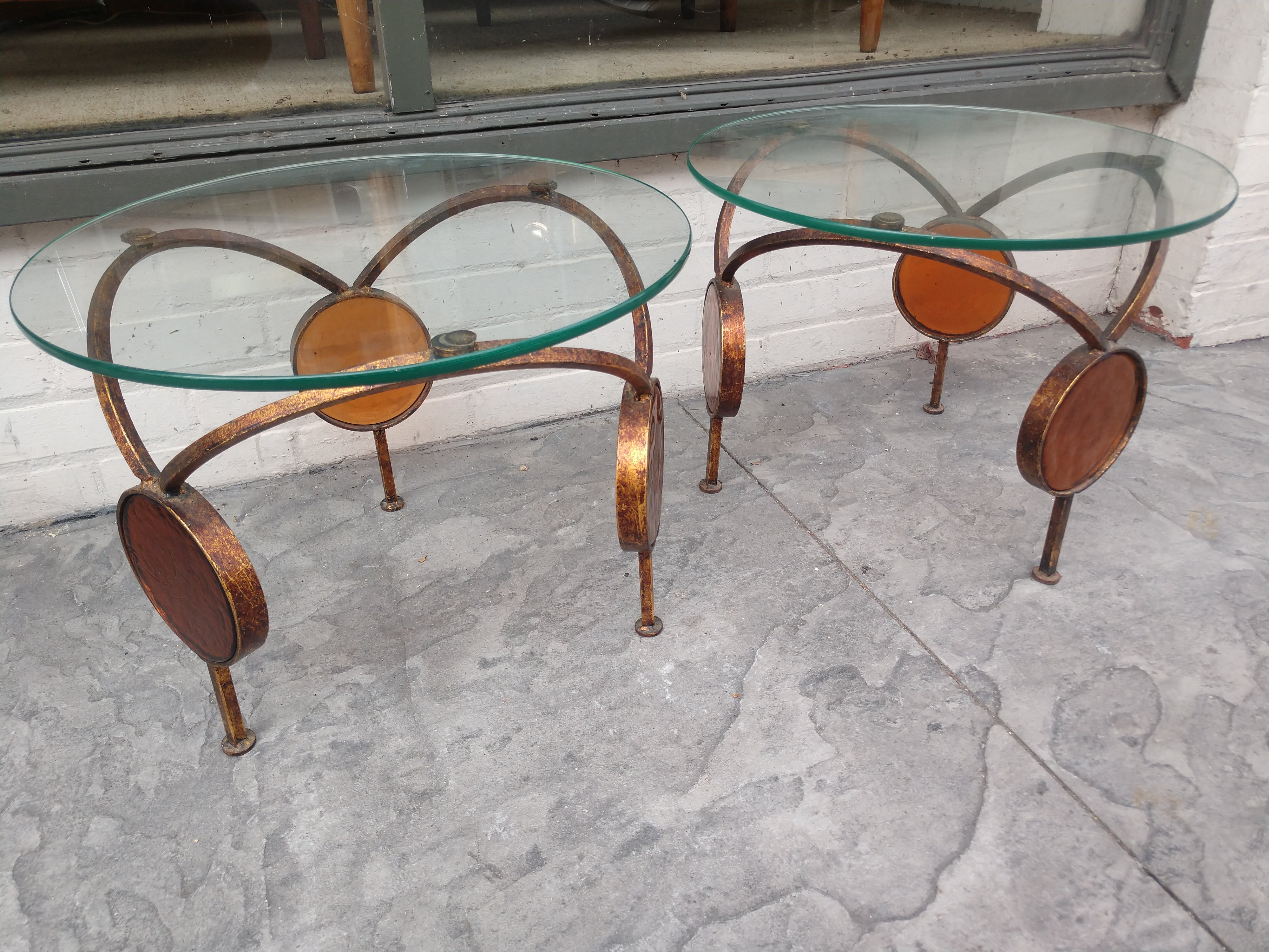 Pair of round Gilt iron with Amber Glass Discs in a hoop form. Rare distinct tables in excellent vintage condition with minimal wear. Glass is perfect. These can be parcel posted.