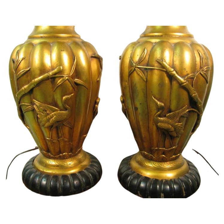 Chinese Chippendale Pair of Chinese Art Deco Book Matched Hand Chased Gilt Metal Table Lamps For Sale