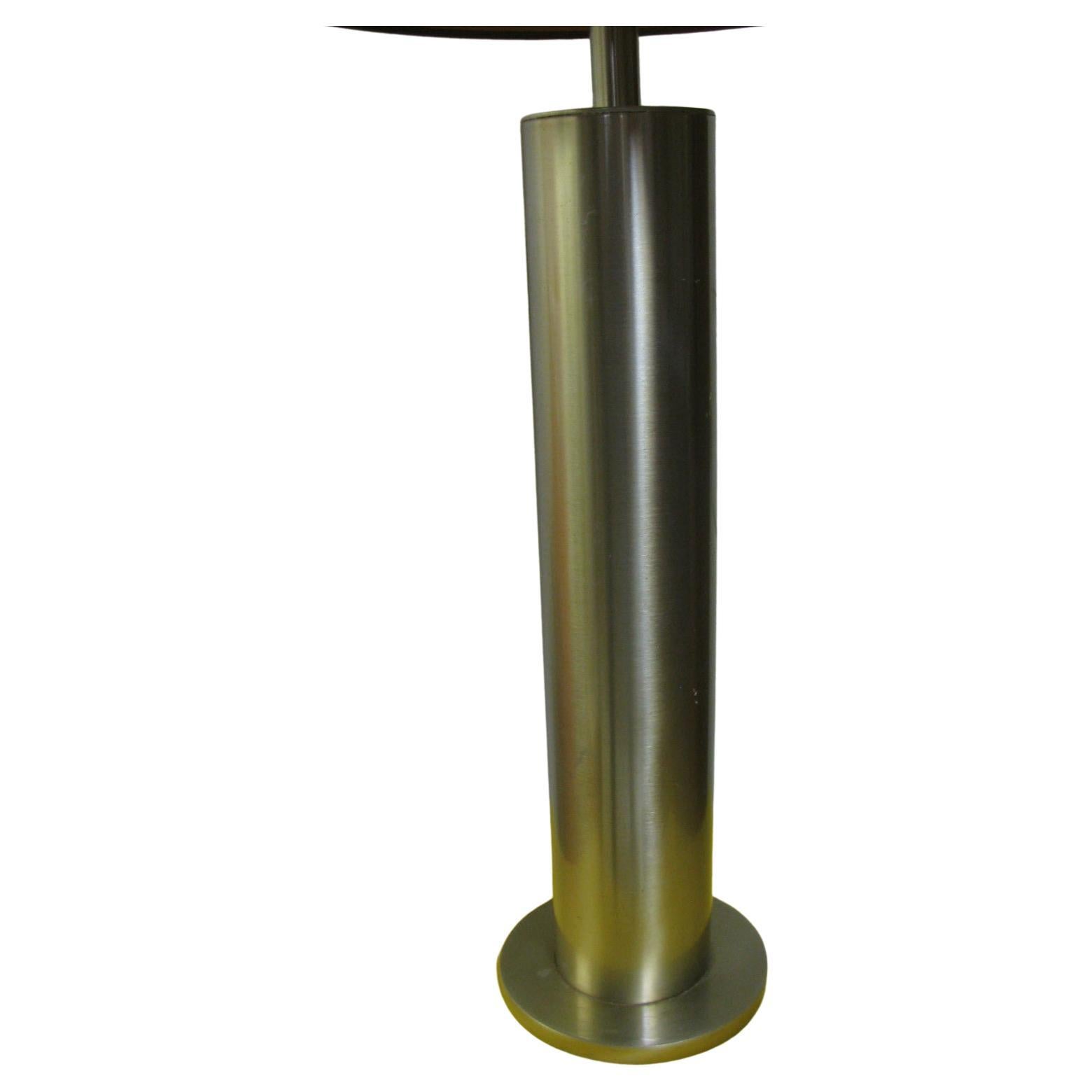 Pair of tall (28.5 inches to the top of the socket) elegant polished stainless steel lamps. Cylindrical form with no seams in the steel. These lamps would look great with black shades, which we do not have at this time. Shades not included. In