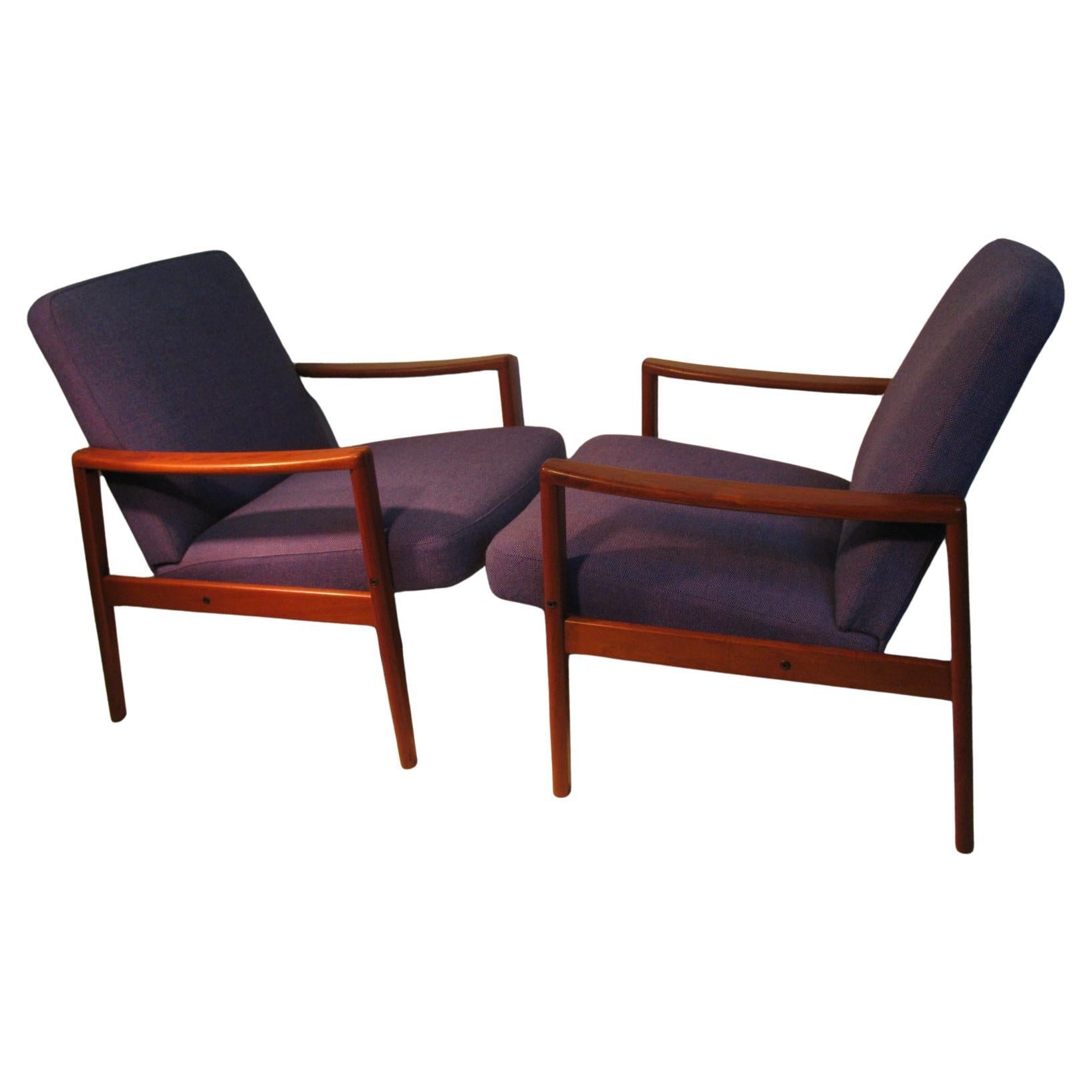 Fabulous pair of upholstered and very comfortable lounge chairs by Ulferts. Dovetailed joinery on the arms. In very good condition, upholstery is also in very good condition. Tagged on bottom. Color is a deep blue.